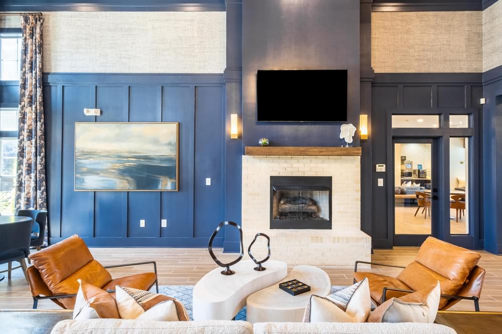 a living room with blue walls and a fireplace with a flat screen tv above it