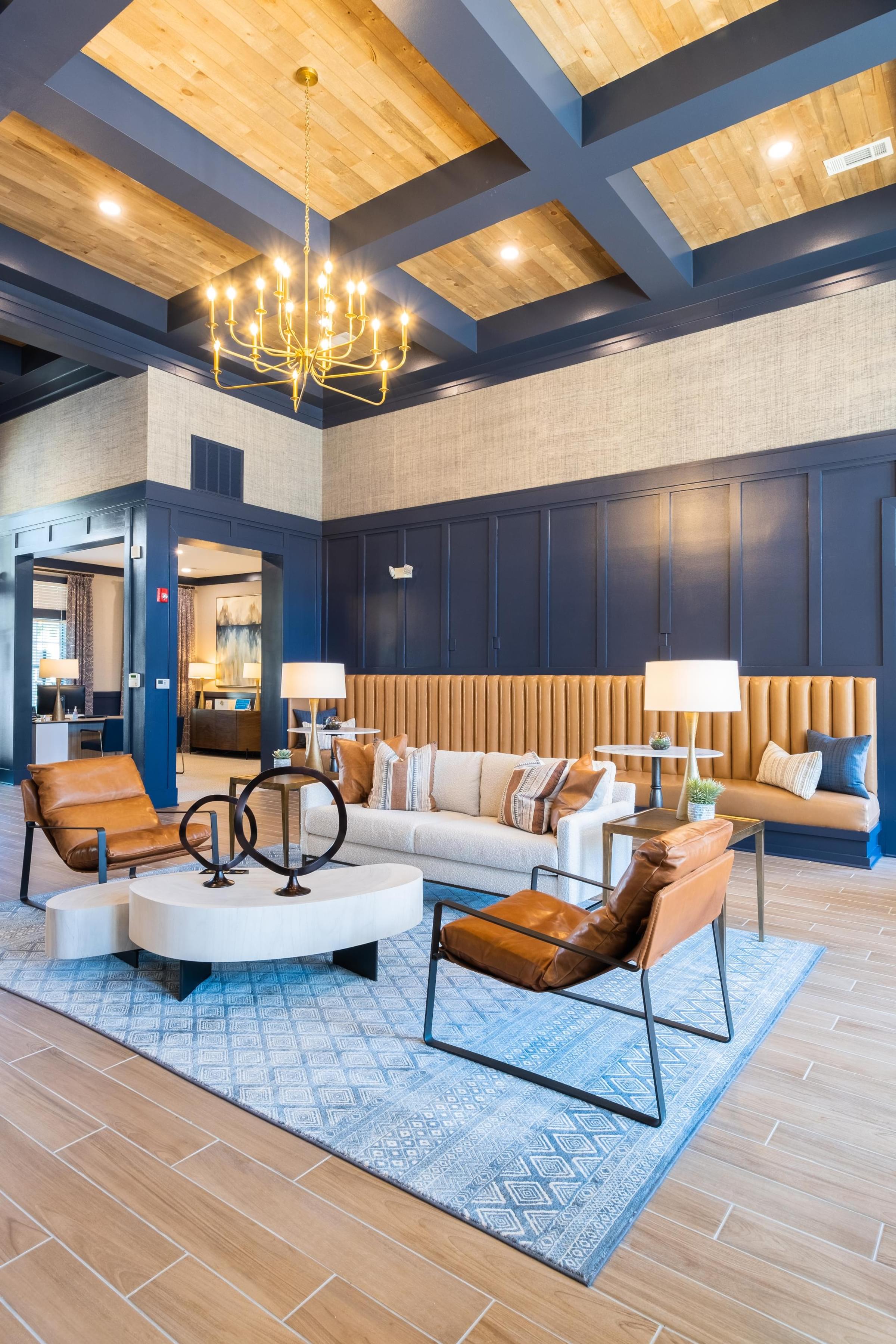 a large room with blue walls and a large chandelier hanging from the ceiling