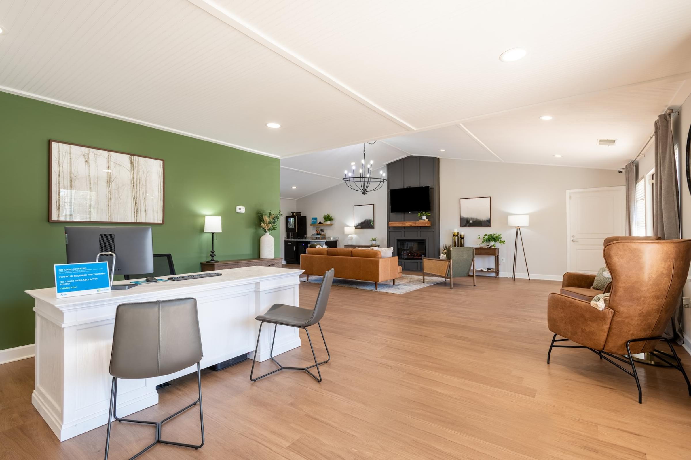 A reception area with a white desk and chairs