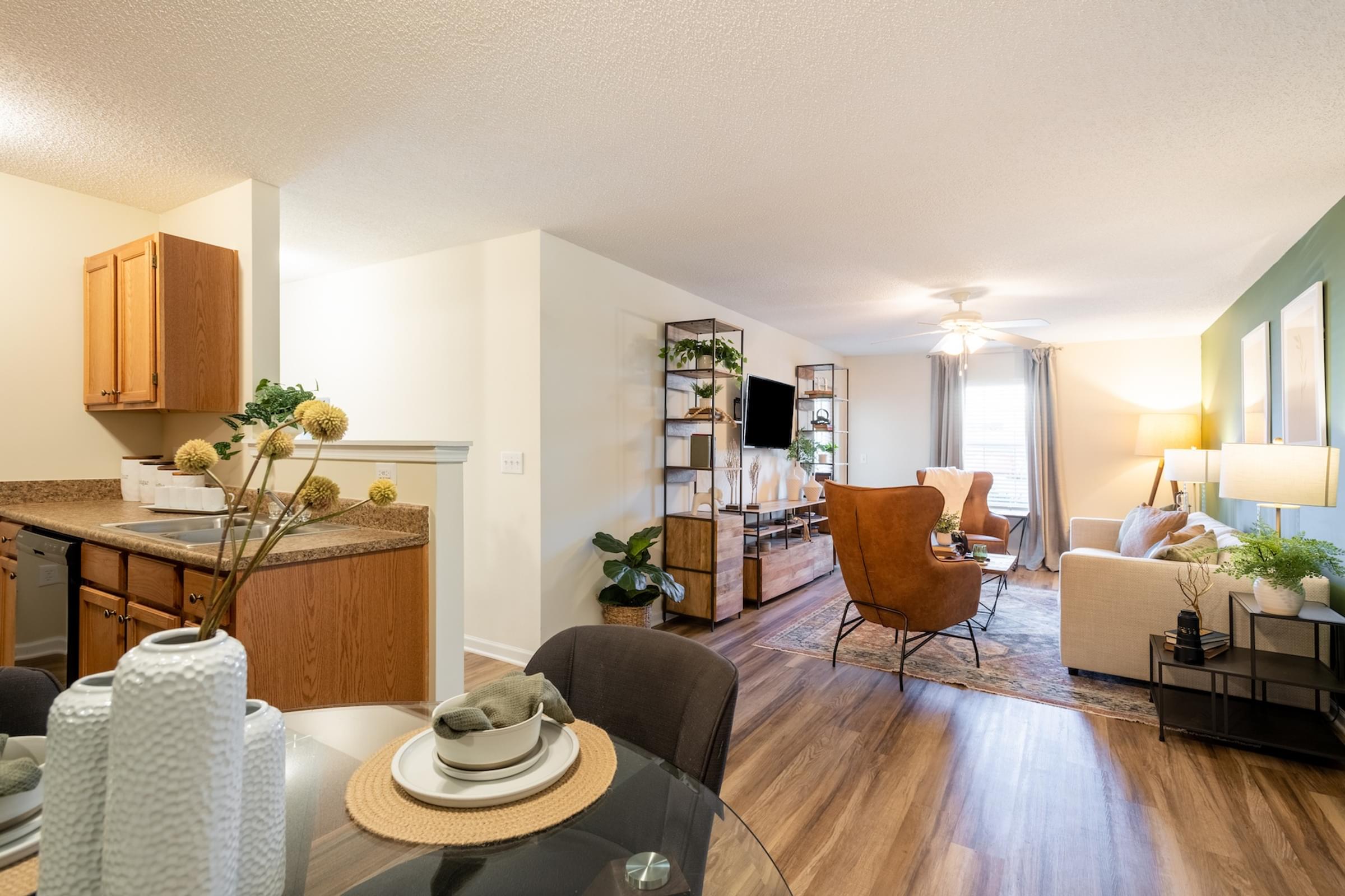 A modern living room with a dining table and chairs.
