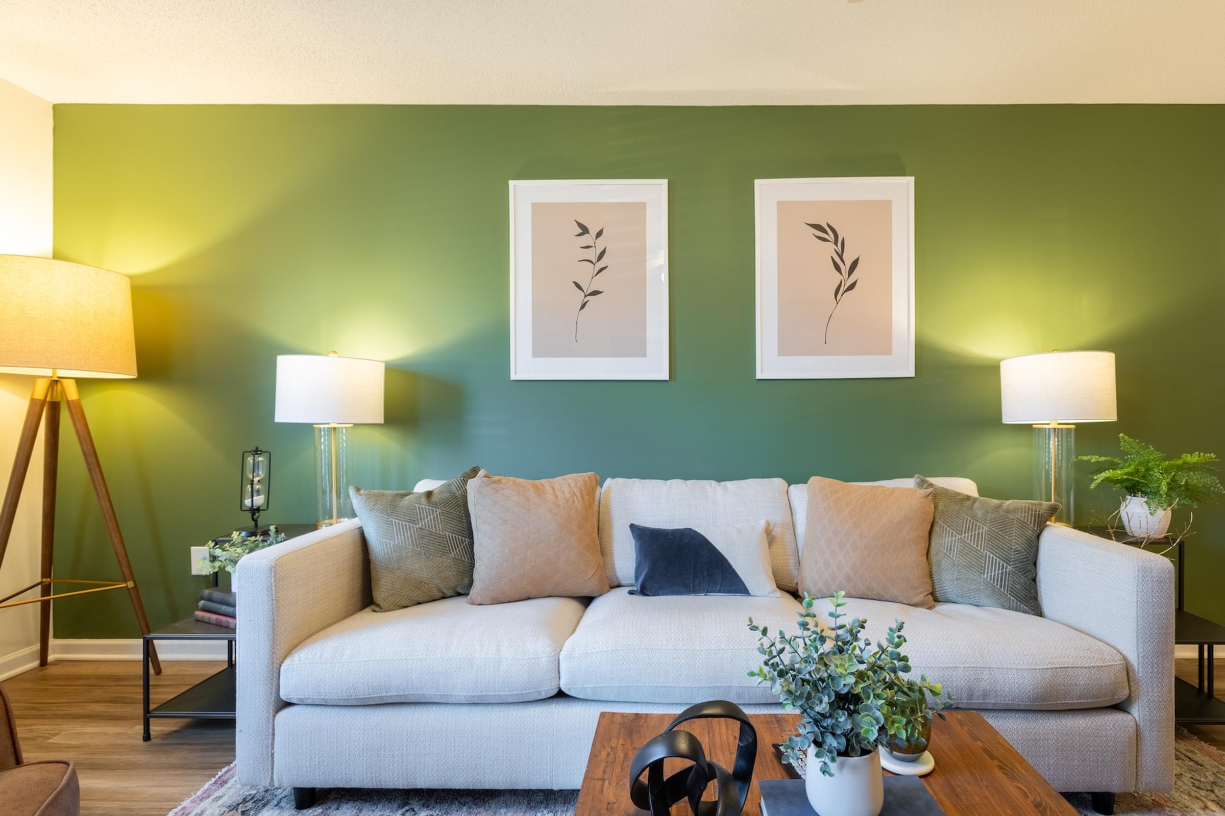 A living room with a white couch and two lamps.