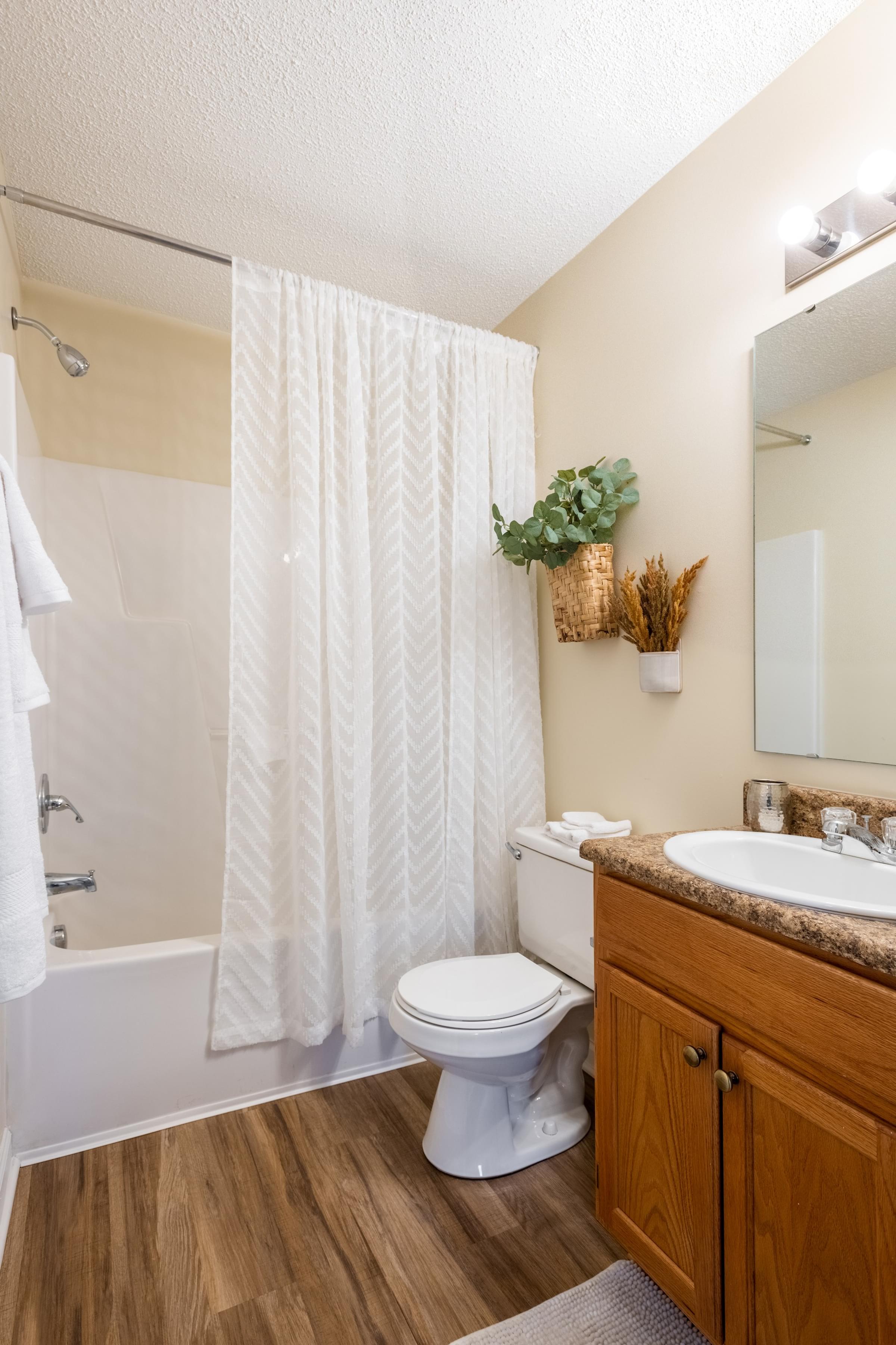 Private Bathroom with Wood-Inspired Vinyl Flooring