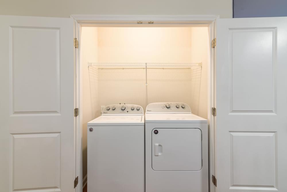 a washer and dryer in a laundry room with white doors