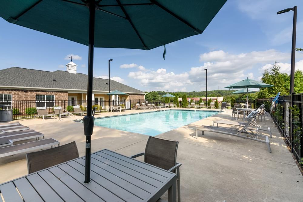 our apartments have a resort style pool with tables and chairs