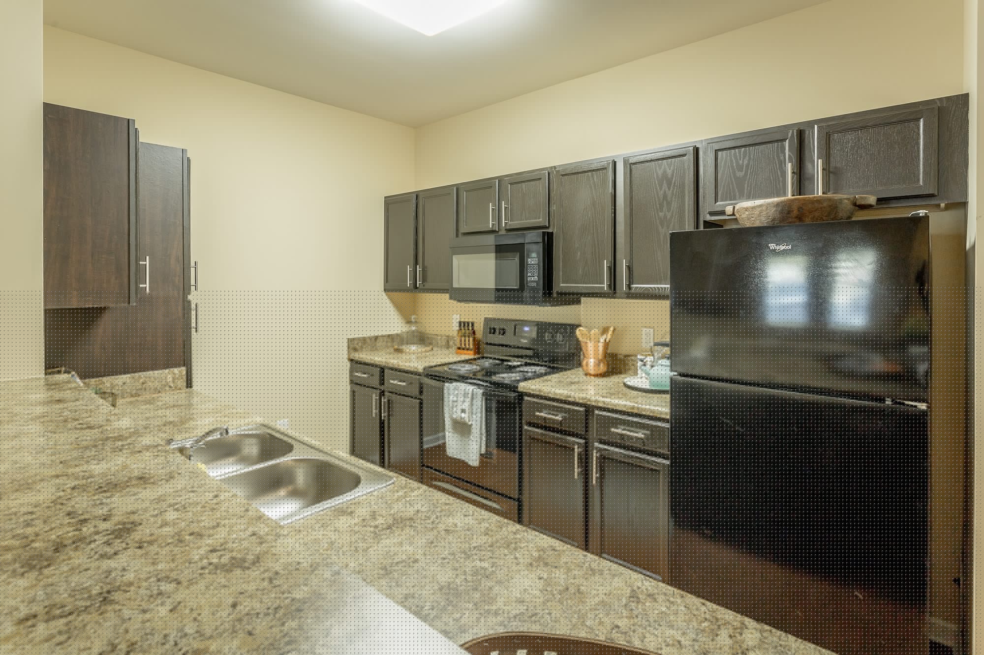 a kitchen with black appliances and granite counter tops