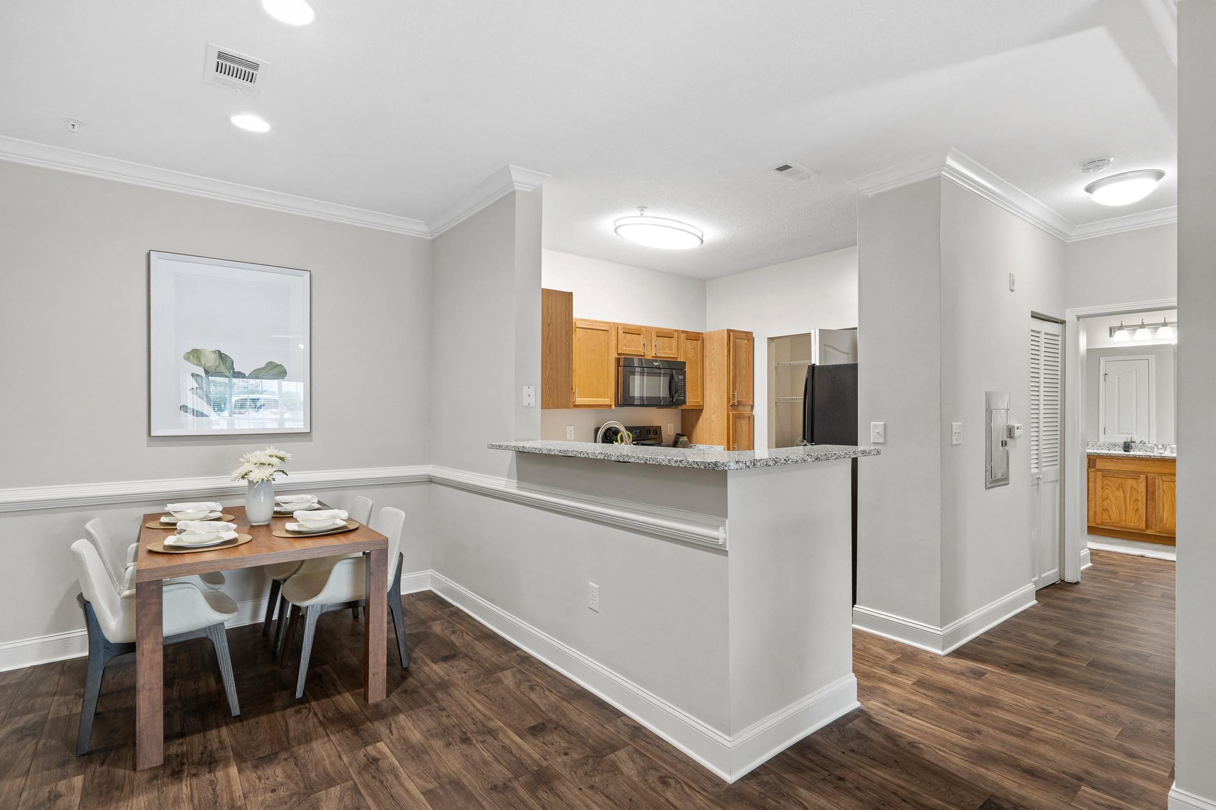 A dining room with a wooden table and chairs