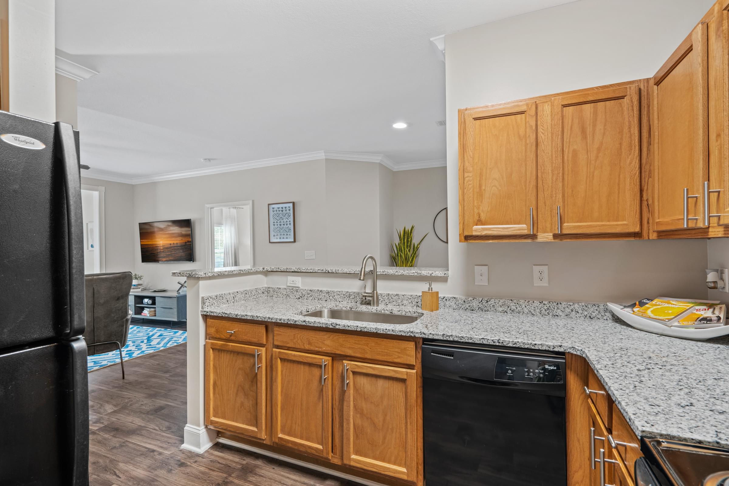 a kitchen with wood cabinets and granite countertops