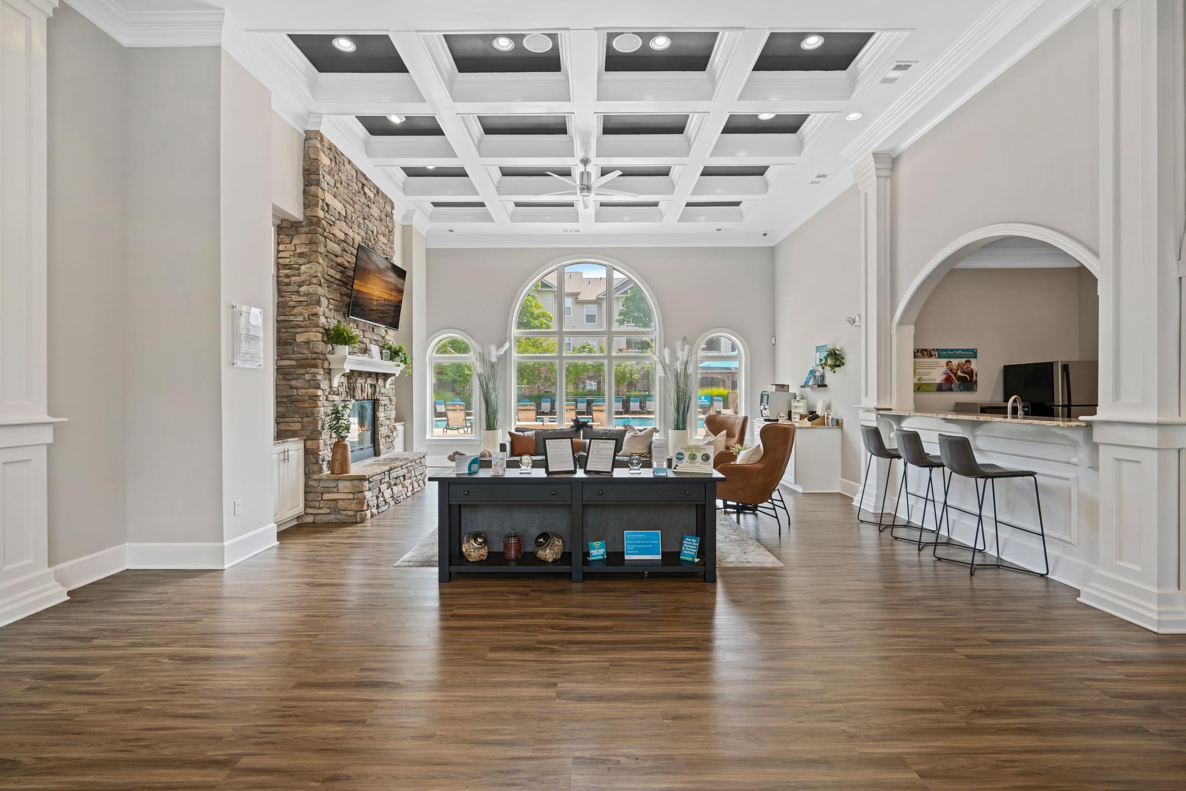 a large room with hardwood floors and a coffered ceiling