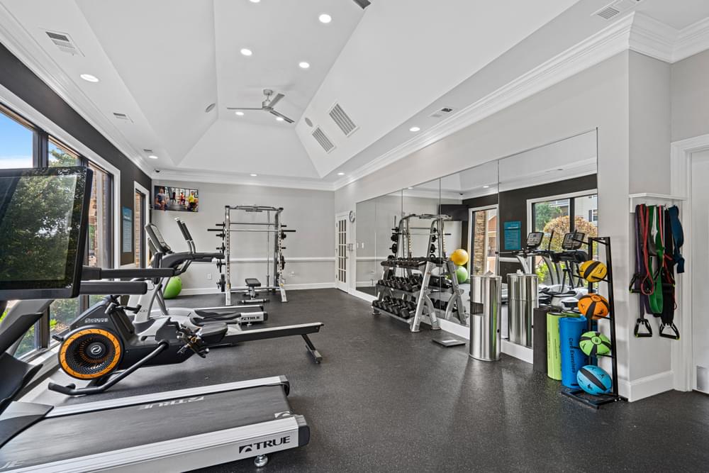 a home gym with exercise equipment and a large window
