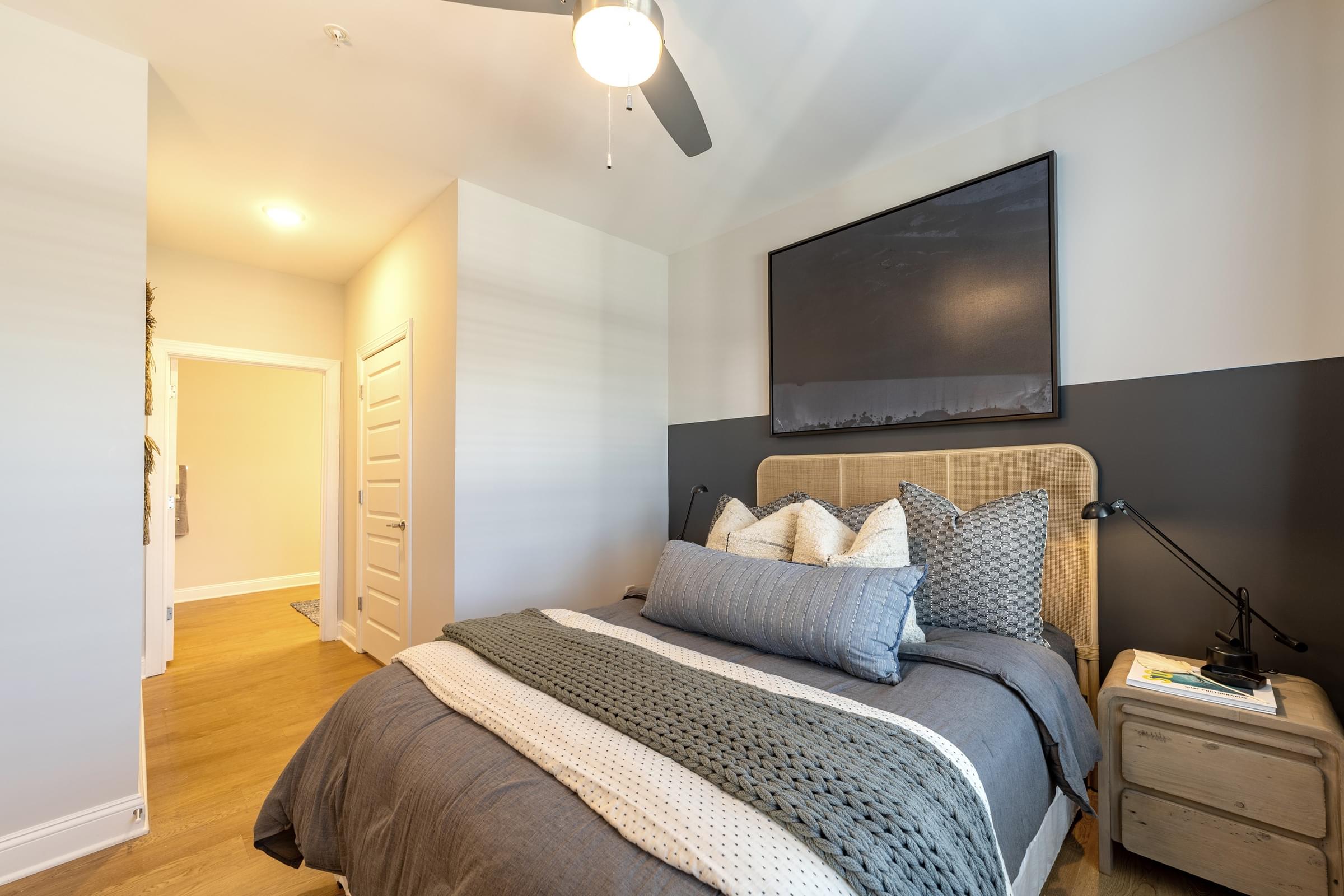 a bedroom with a bed and a tv on the wall