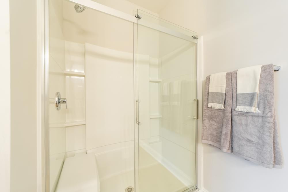 a shower with a glass door in a bathroom