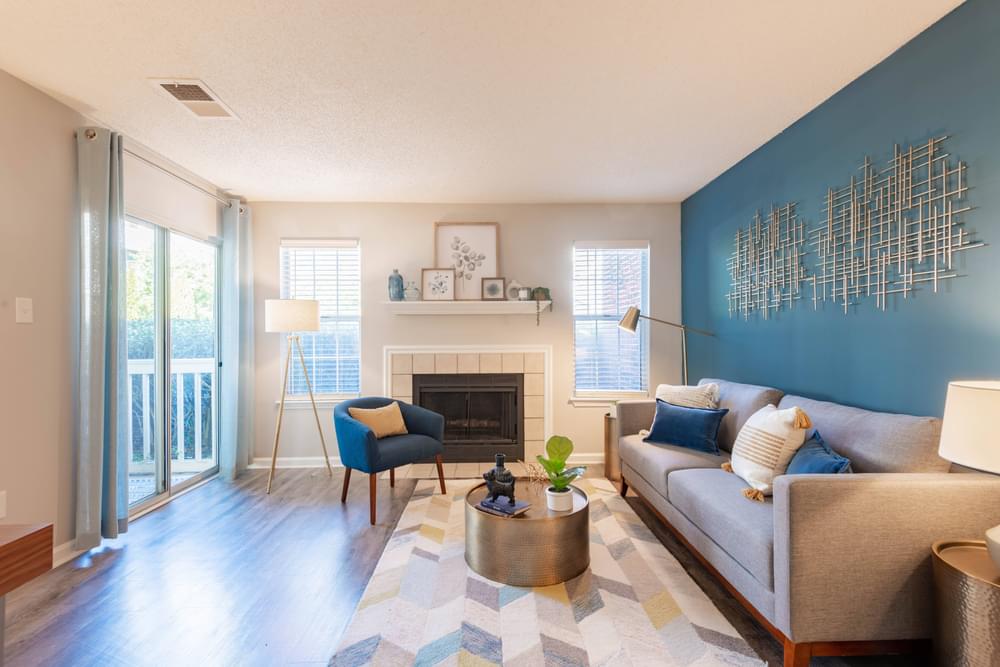 a living room with a blue accent wall and a fireplace