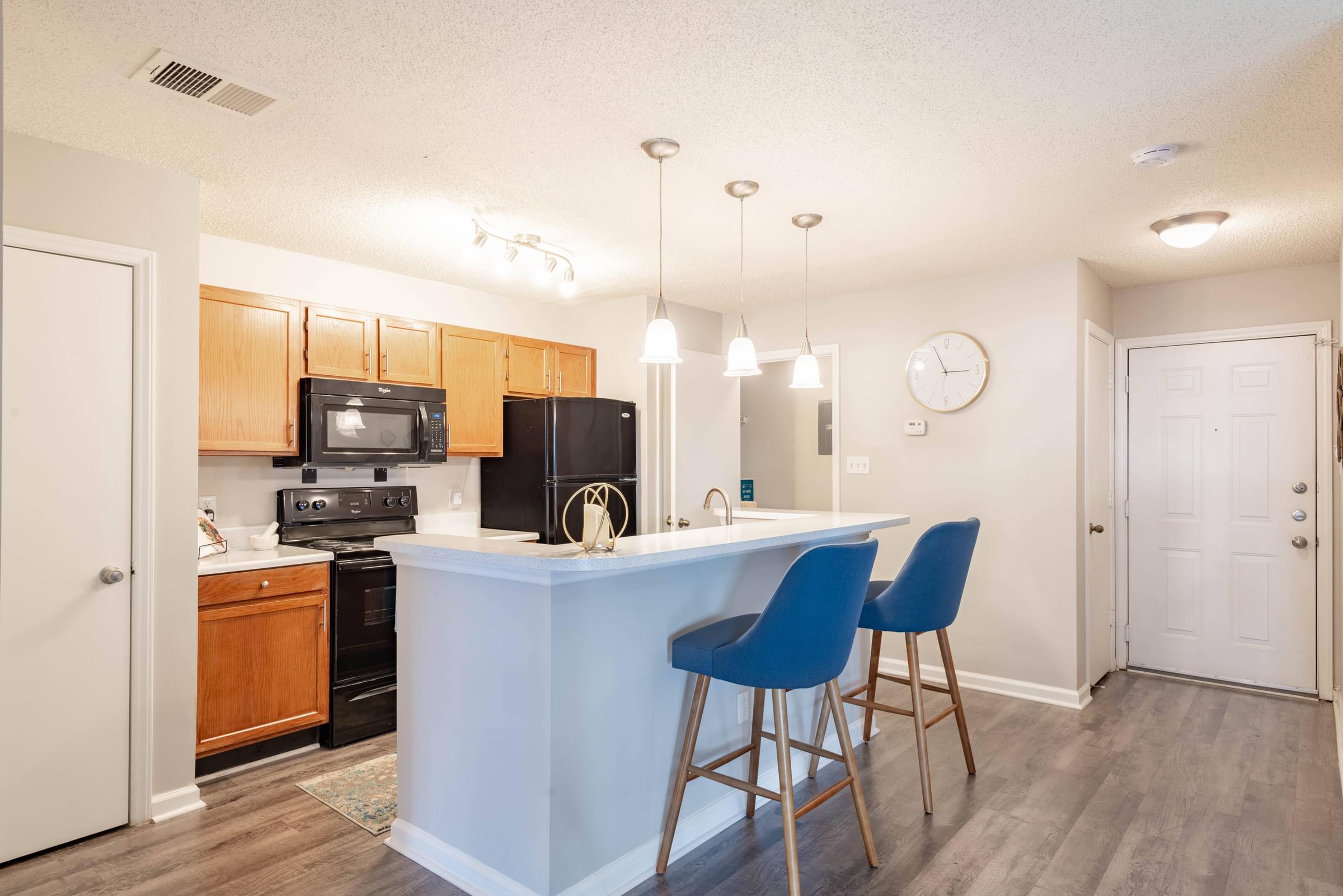 Spacious Kitchen with Breakfast Bar, Built-in Microwave, and Sleek Black Appliances