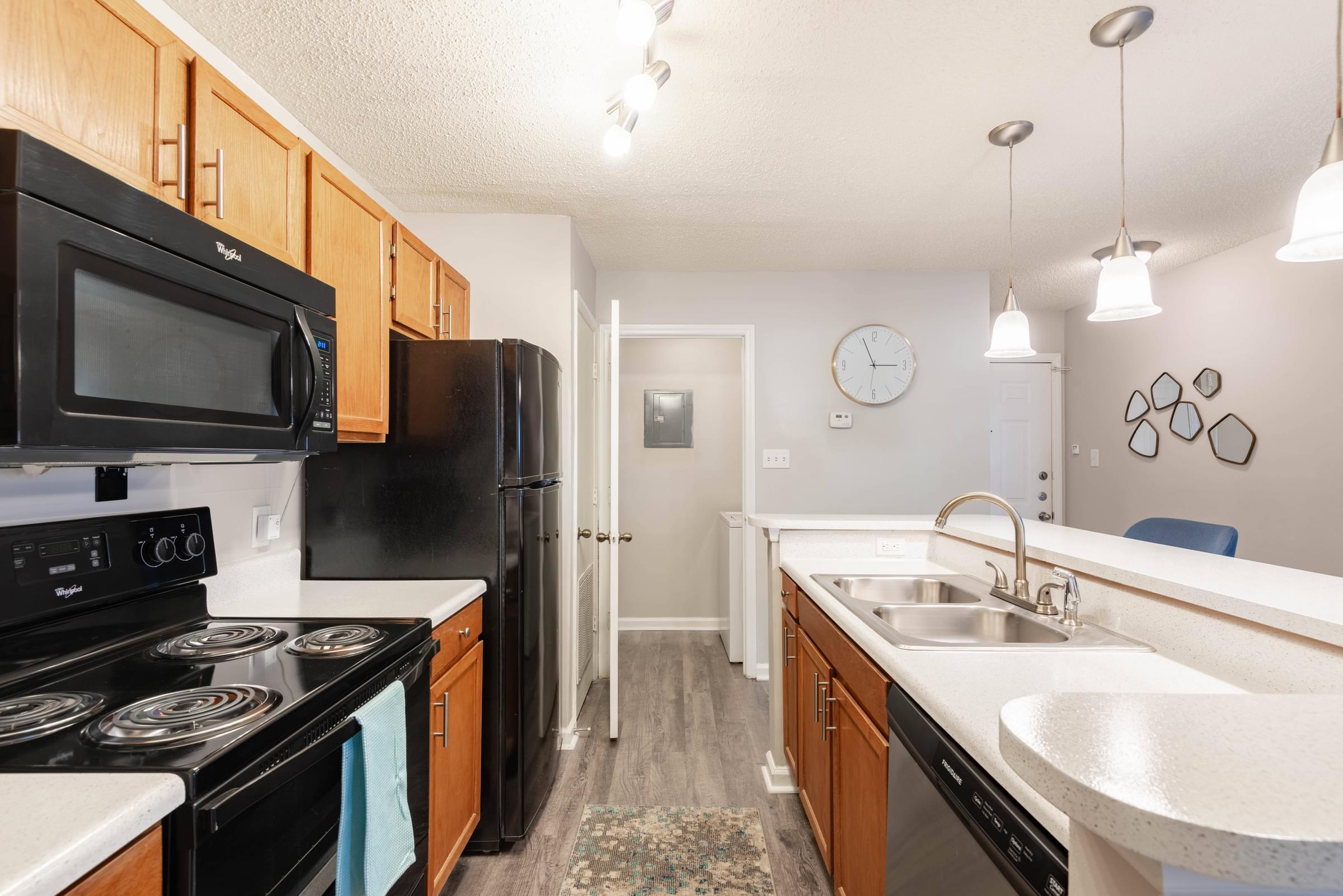 a kitchen with black appliances and white counters