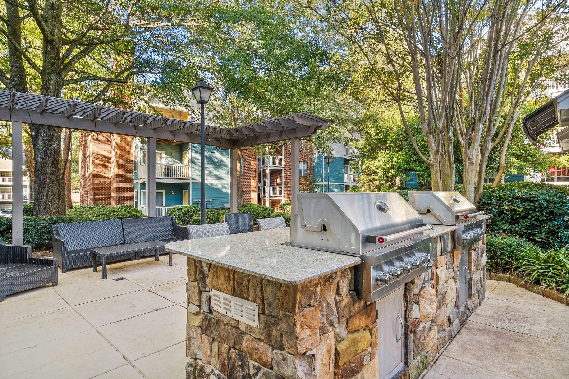 the preserve at ballantyne commons outdoor grill area with seating and trees