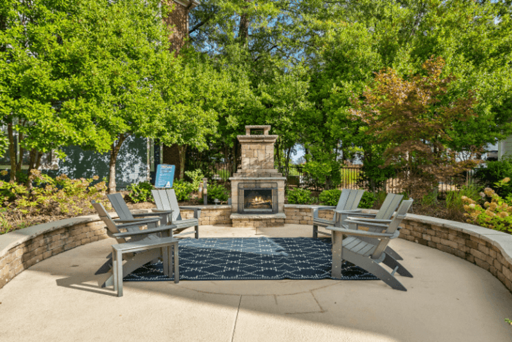 an outdoor patio with chairs and a fire pit