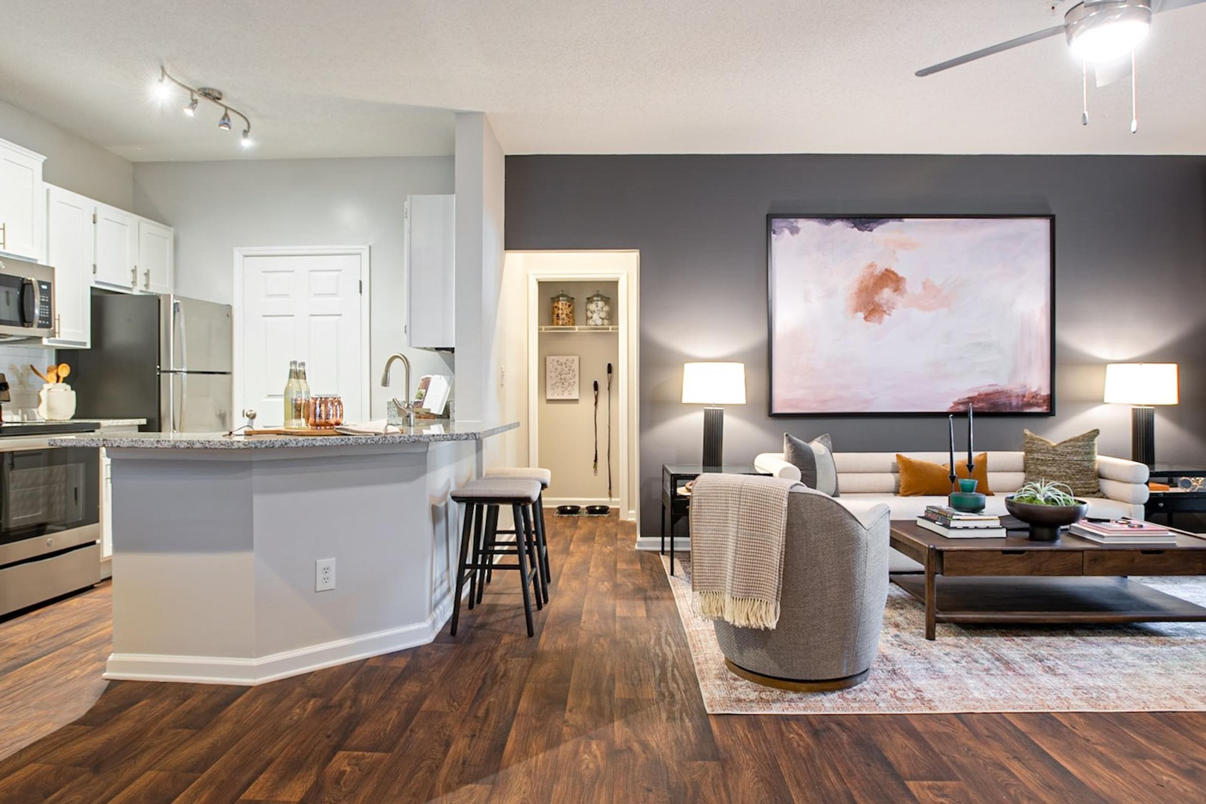 a living room with a kitchen and a couch and a table