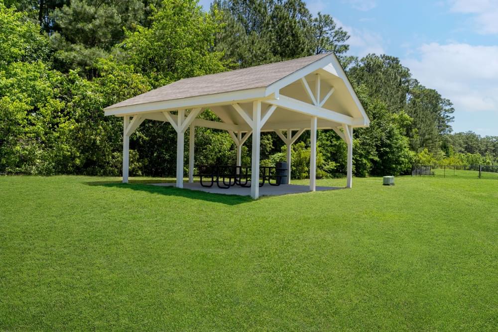 a pavilion with a picnic table under it