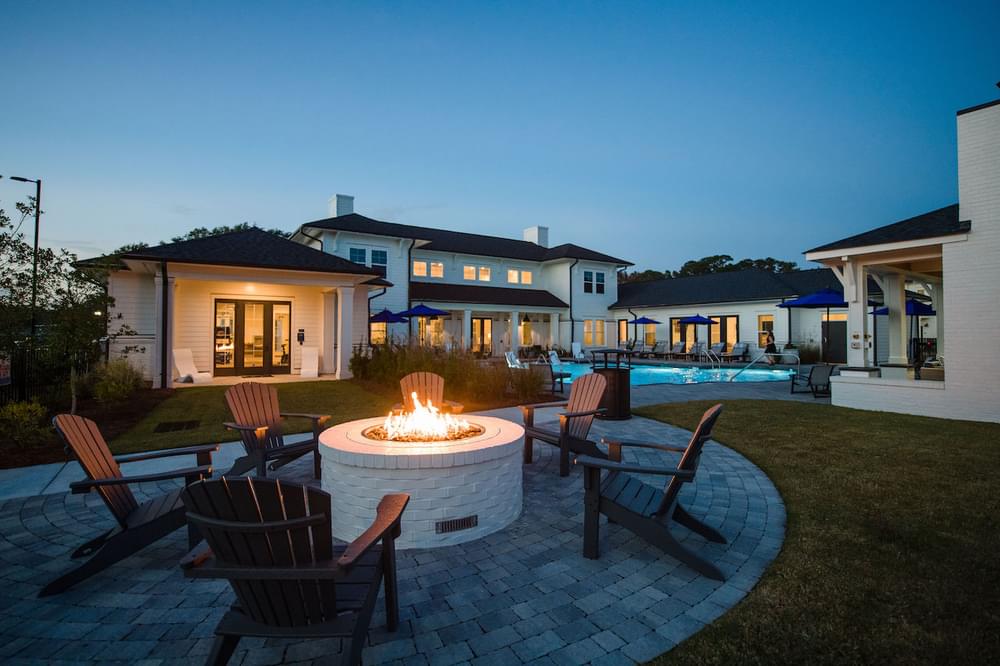 a backyard with a fire pit and chairs