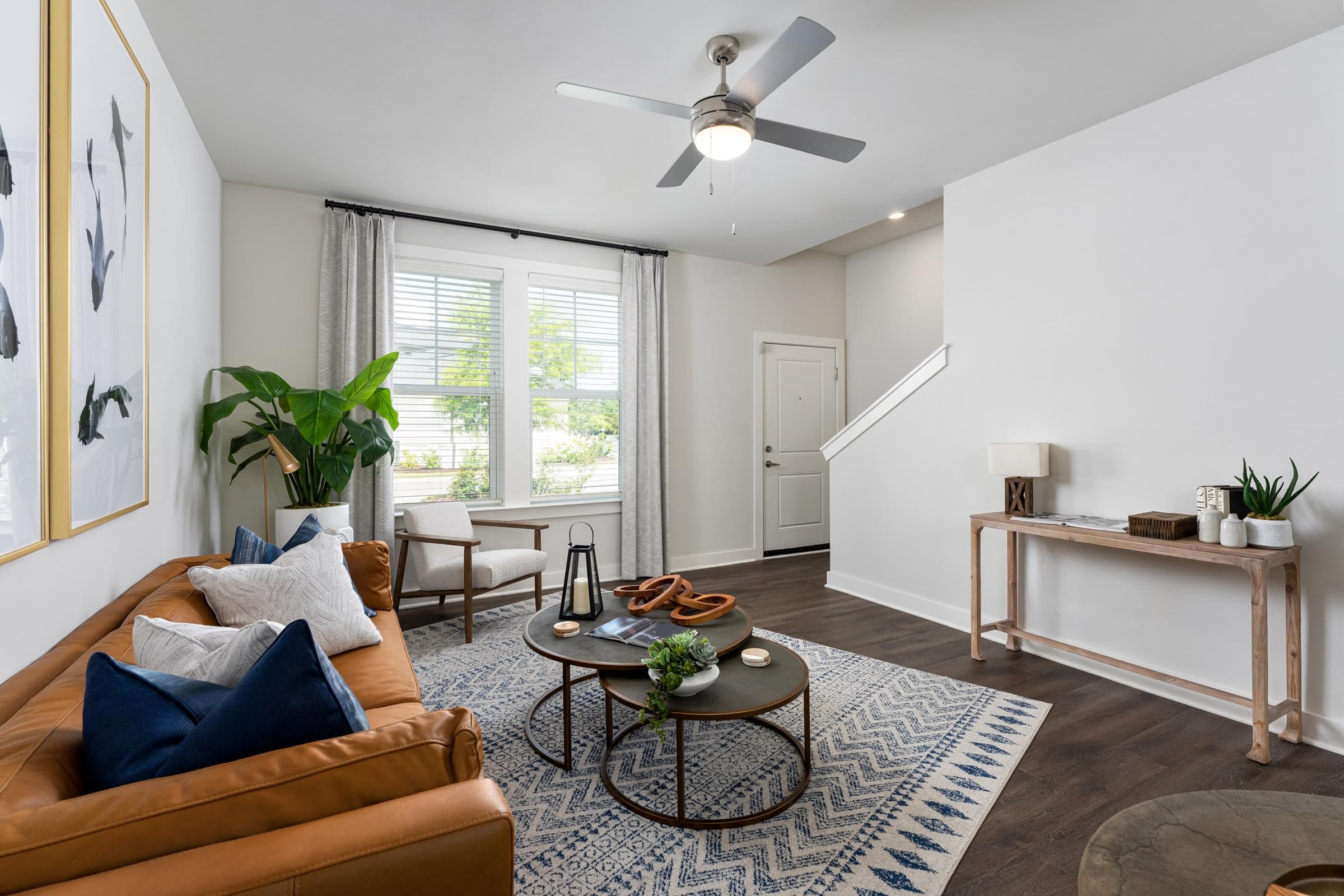 A living room with a brown leather couch and a coffee table.