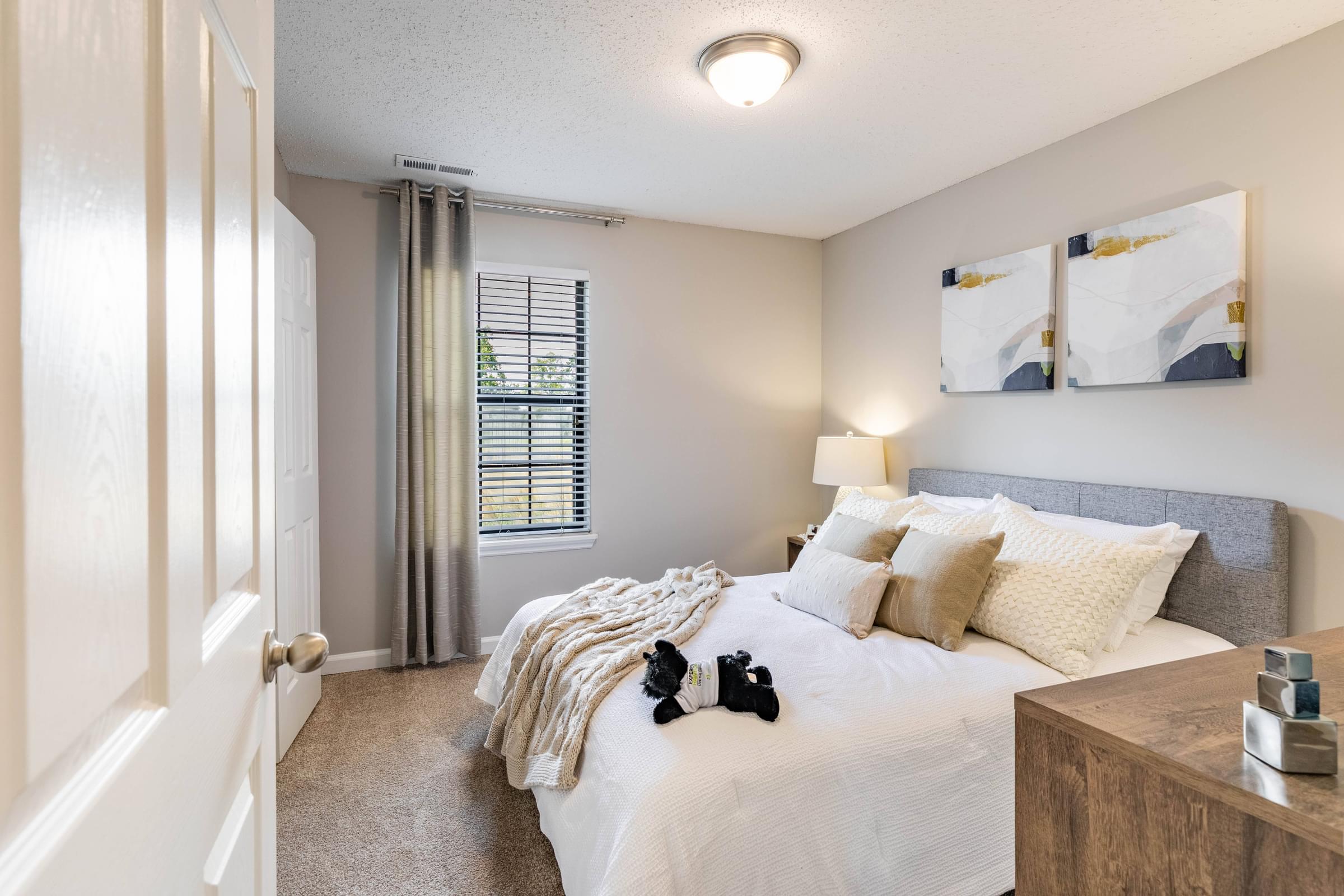 a bedroom with a large bed and a window