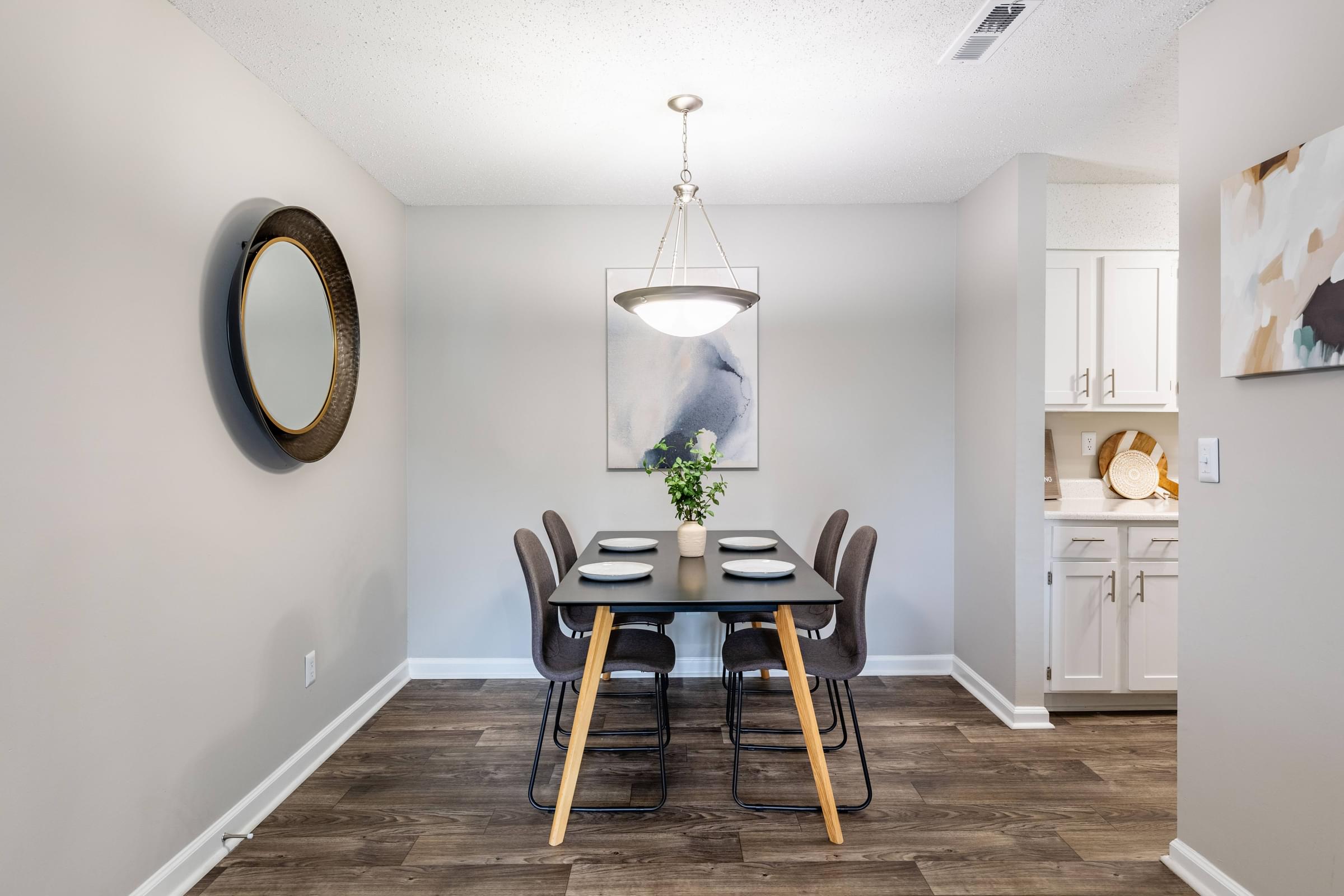 a dining room with a table and chairs and a chandelier