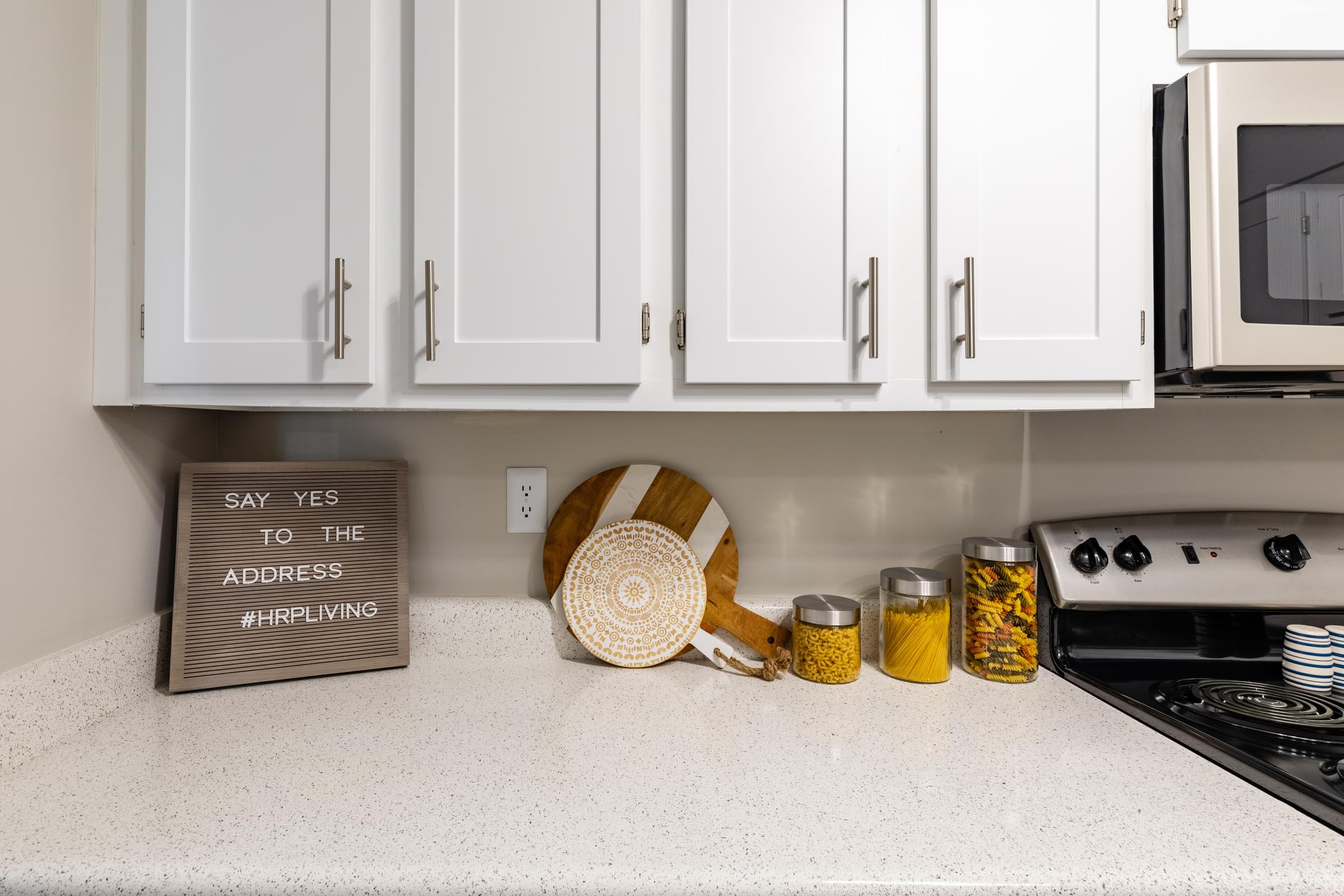 a kitchen with white cabinets and a sign that says say yes to the address frightening