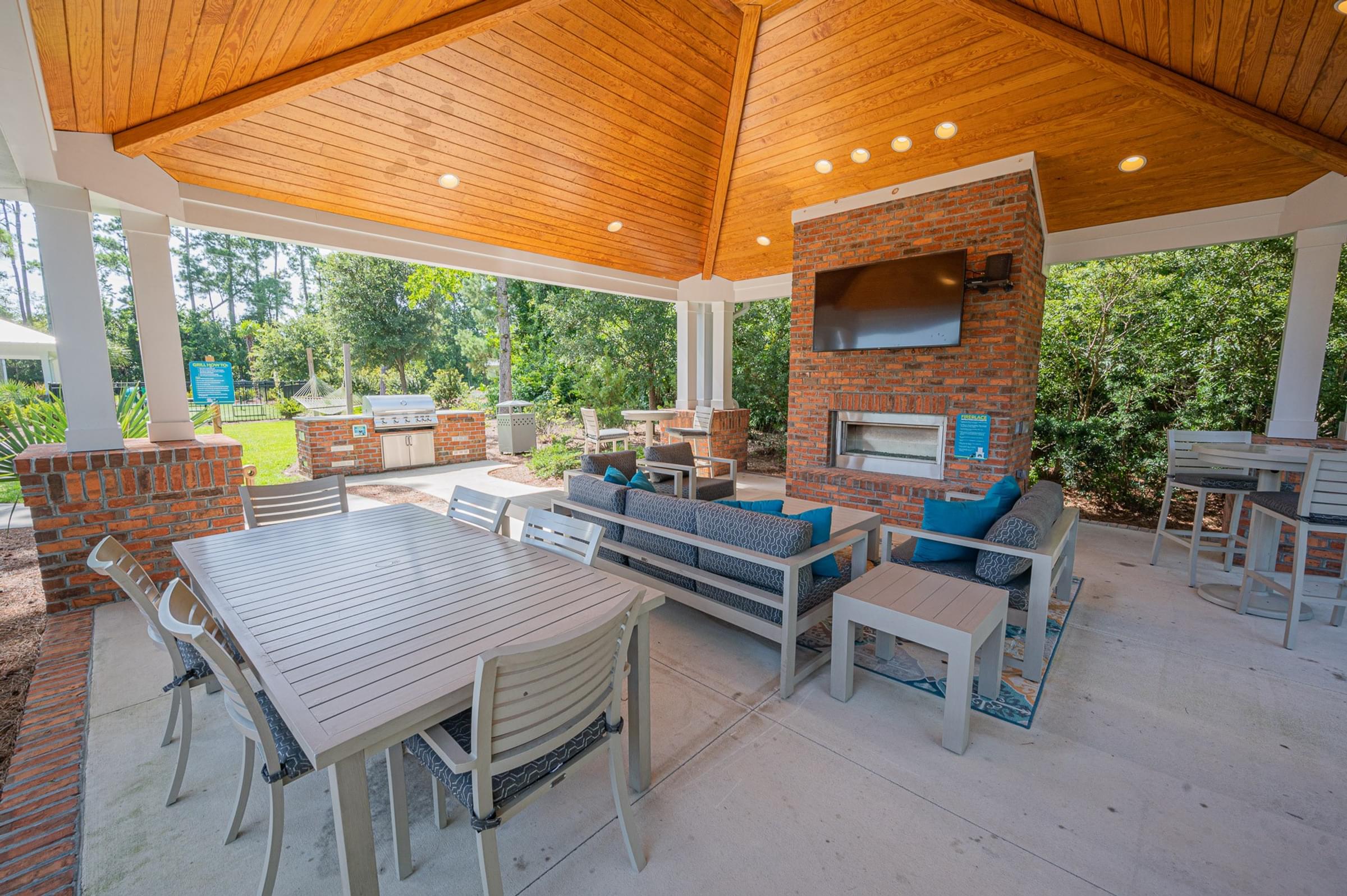 Outdoor Covered Lounge with Fireplace, TV, Grilling Station and Ample Seating