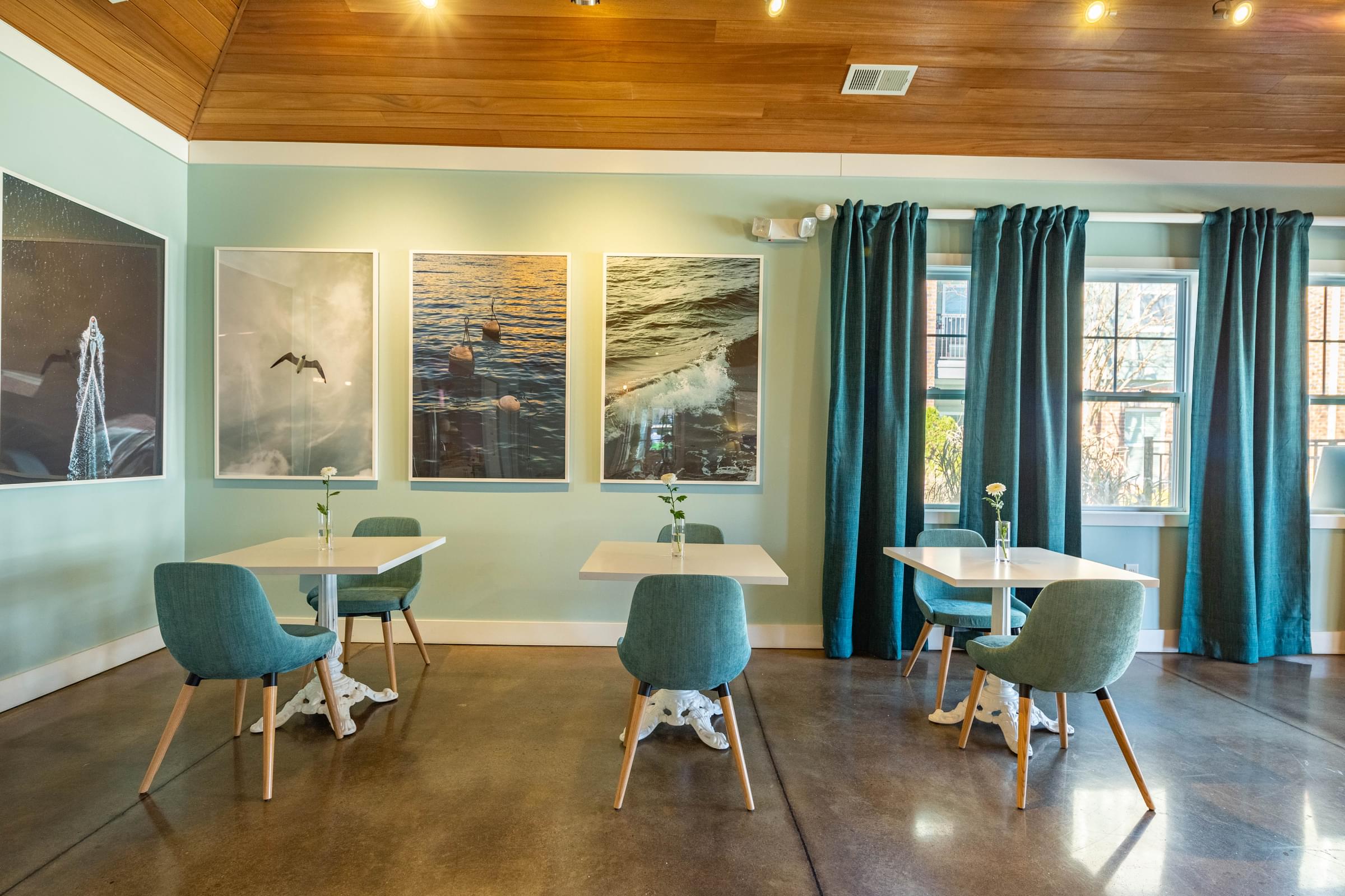 A room with a wooden ceiling and a table with chairs