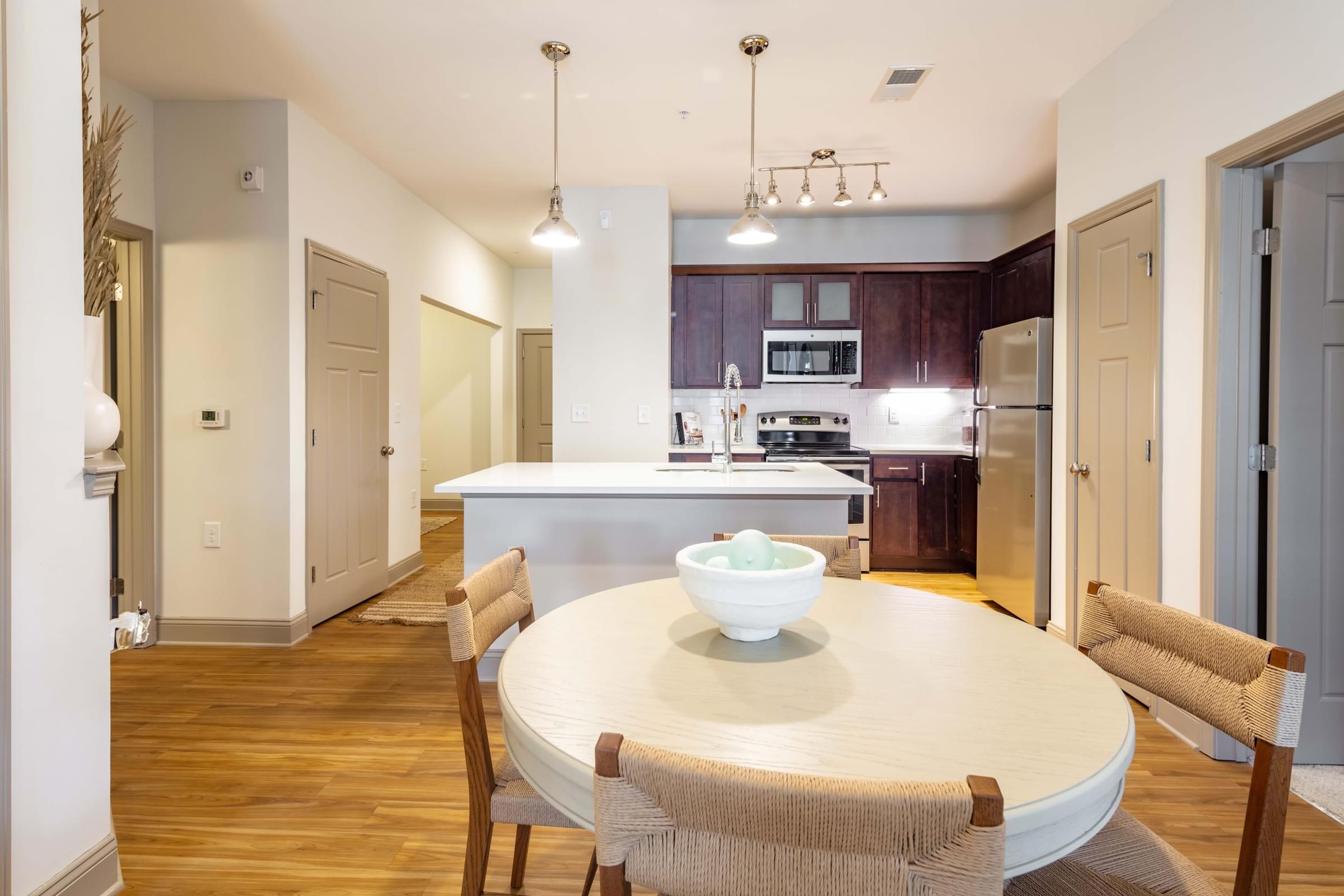 A modern kitchen with a dining table and chairs