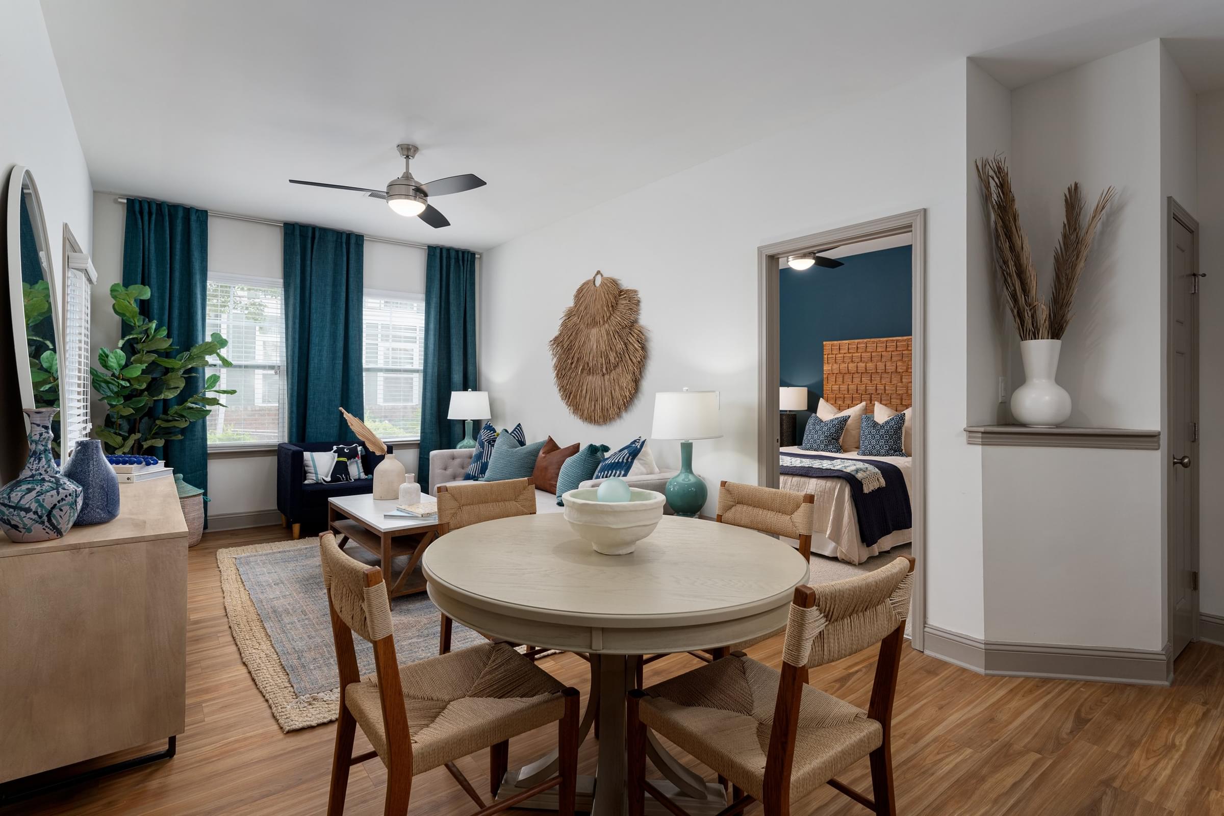 A dining room with a round table and chairs.