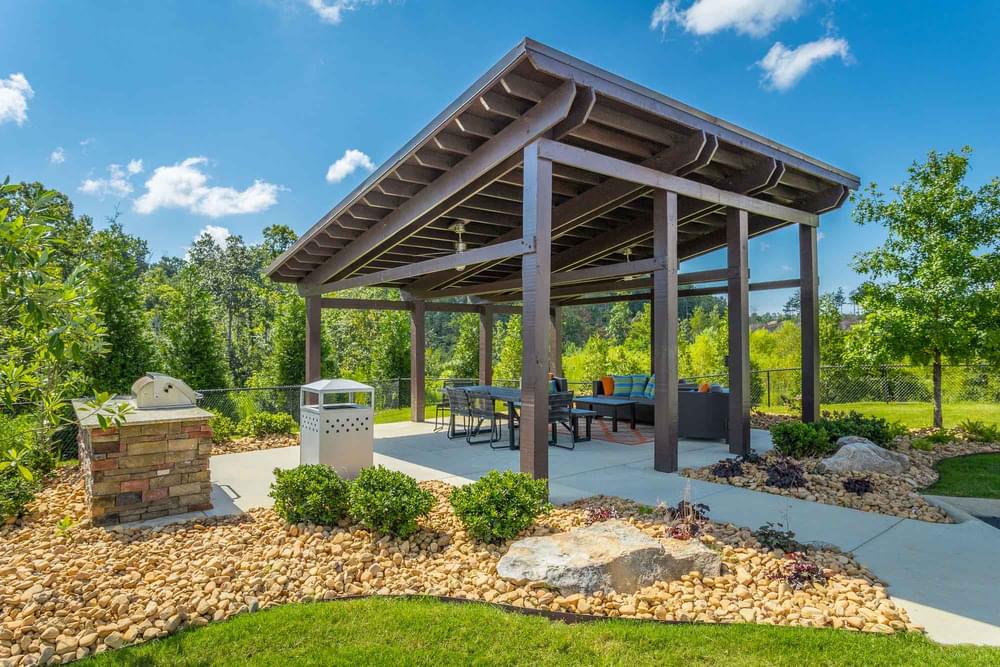 a pavilion with a fire pit and a picnic table