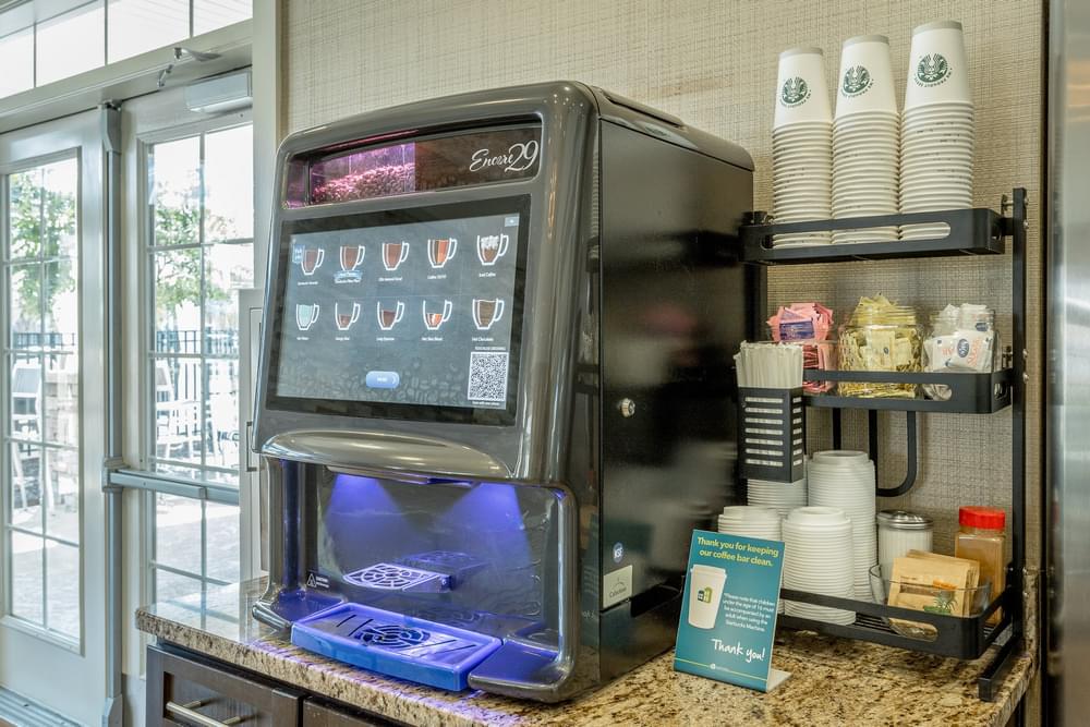 a coffee machine on a counter next to a window