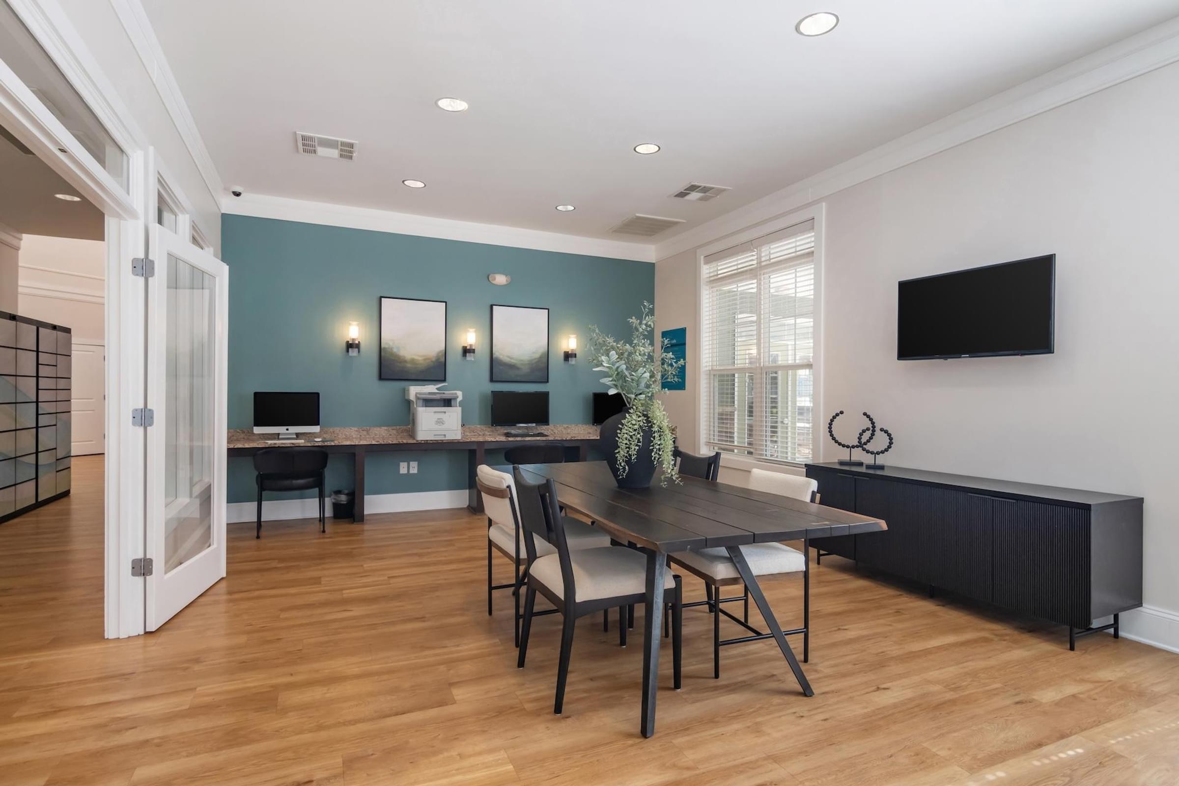 A dining room with a table and chairs.