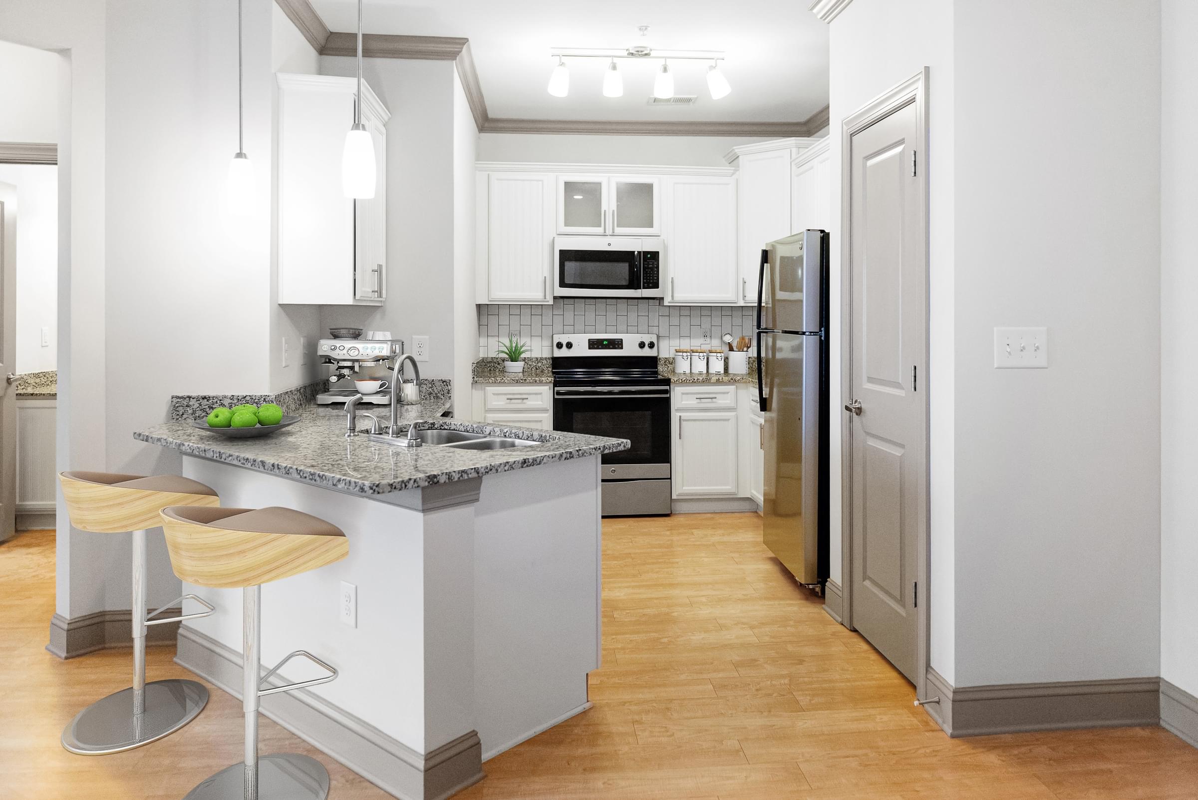 Large Modern Kitchen with White Cabinets and Stainless Steel Appliances