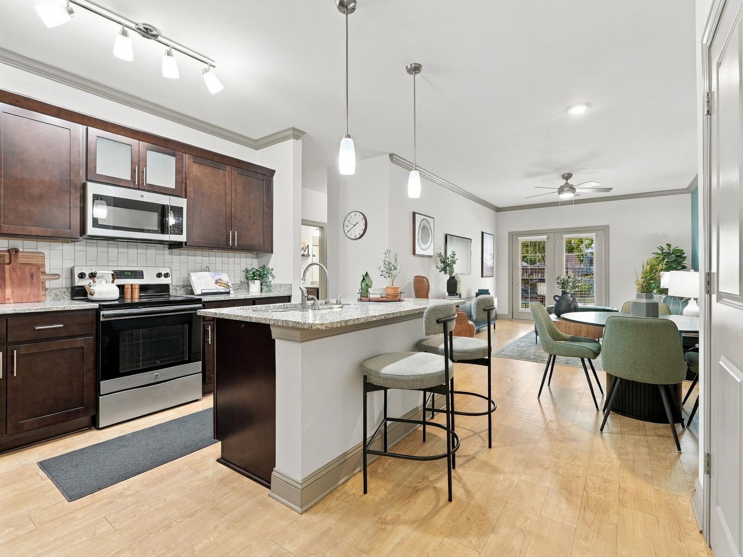 A kitchen with a bar area and a dining table.