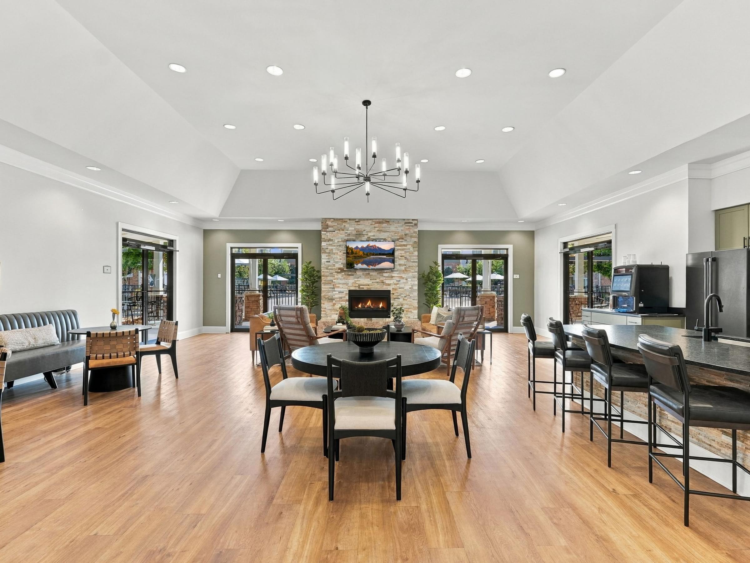 A modern dining room with a stone fireplace and a large table set for six.