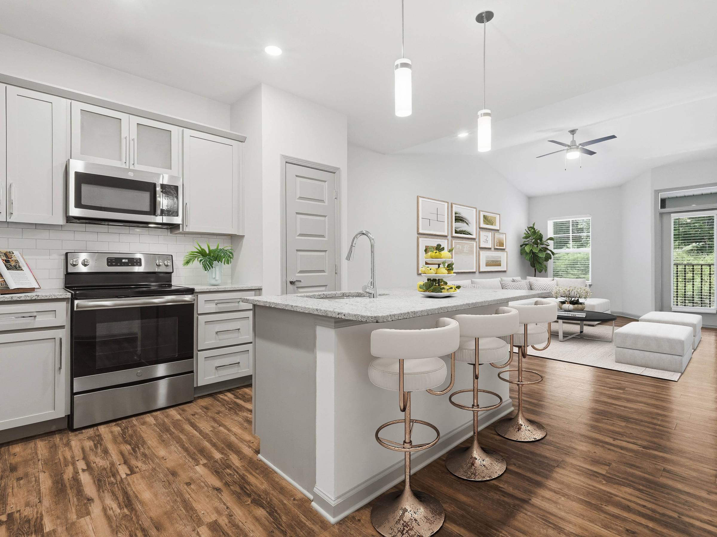 A modern kitchen with a white island and stainless steel appliances.