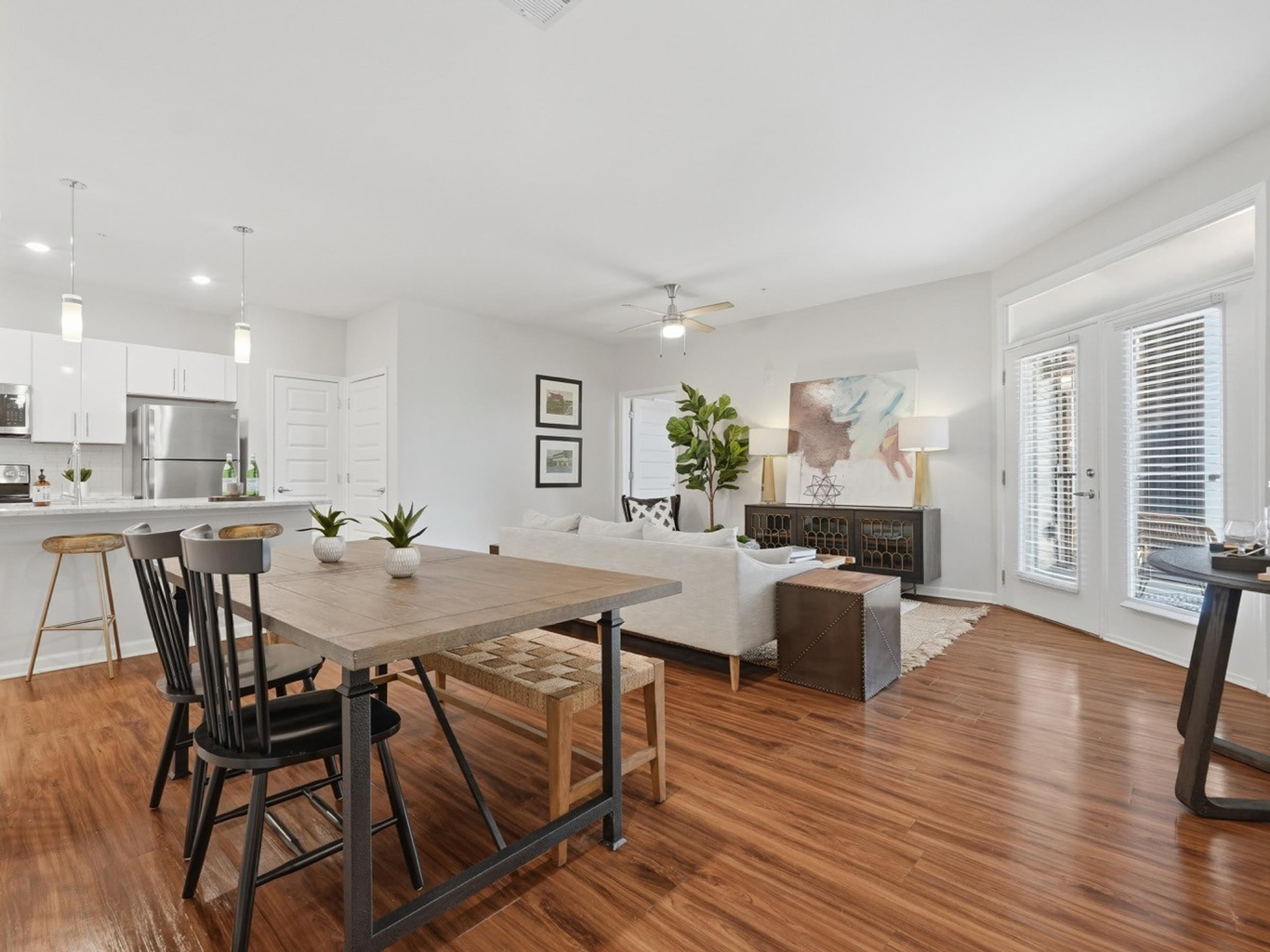 A modern kitchen with a dining table and chairs.