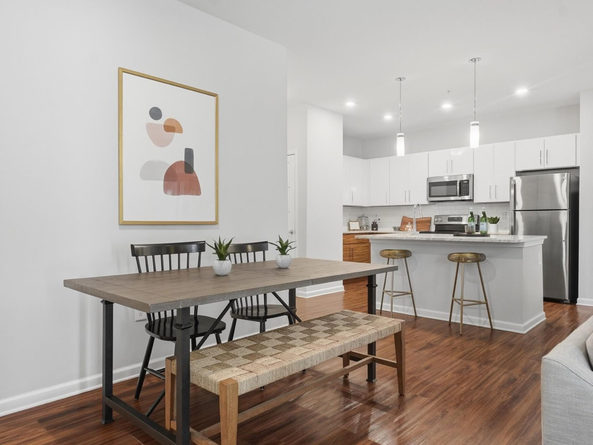 A modern kitchen with a dining table and chairs.