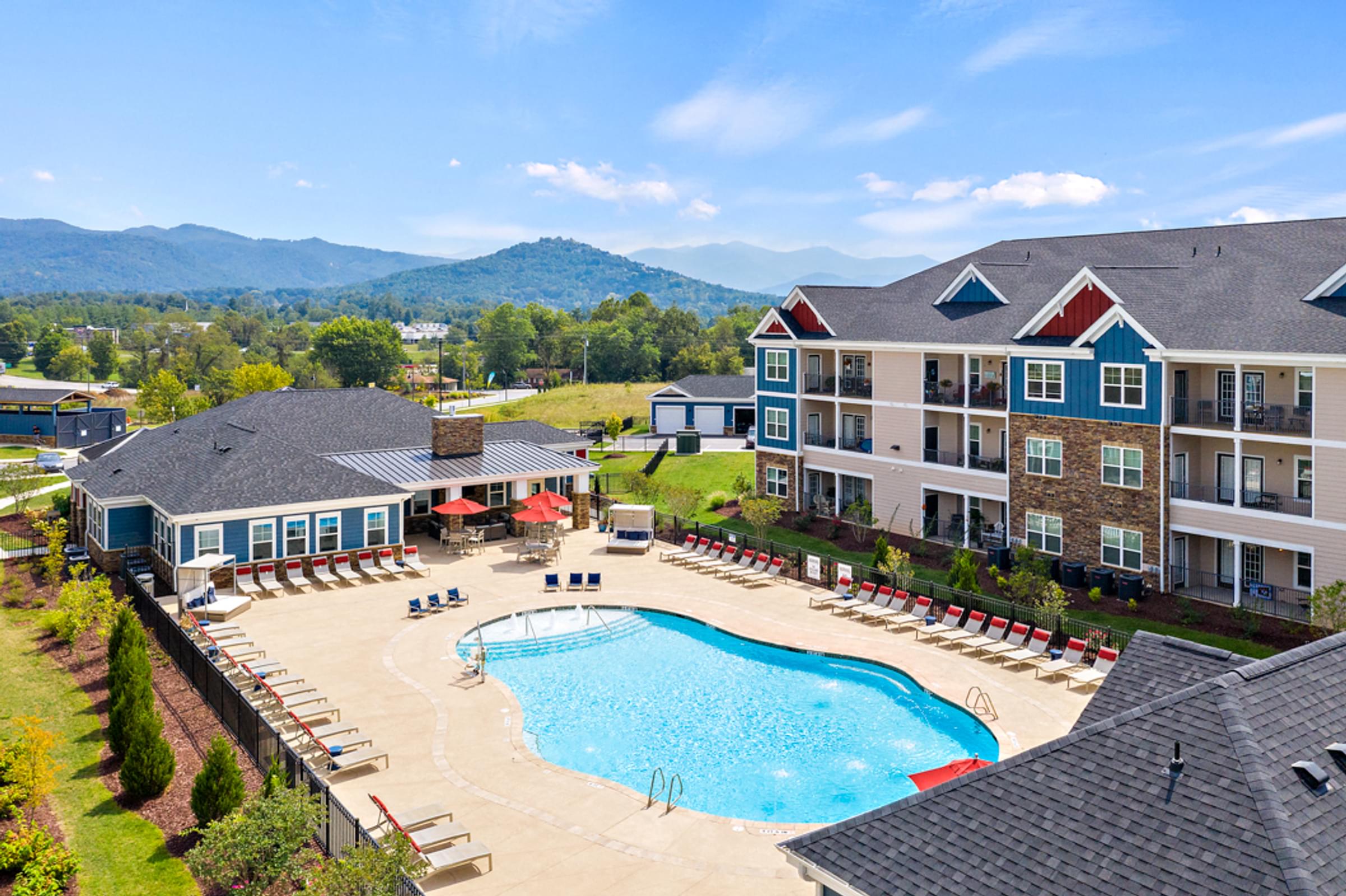 an aerial view of an outdoor swimming pool and resort buildings