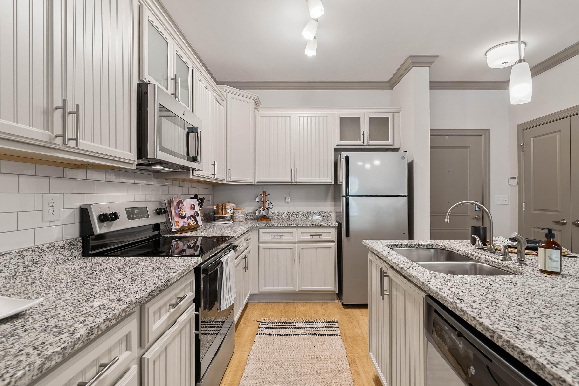modern upgraded kitchen with granite countertops and stainless steel appliances