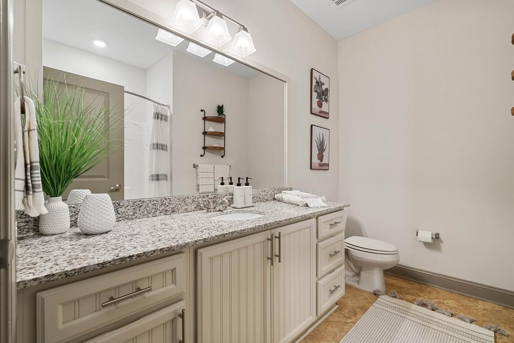modern upgraded bathroom with granite countertops