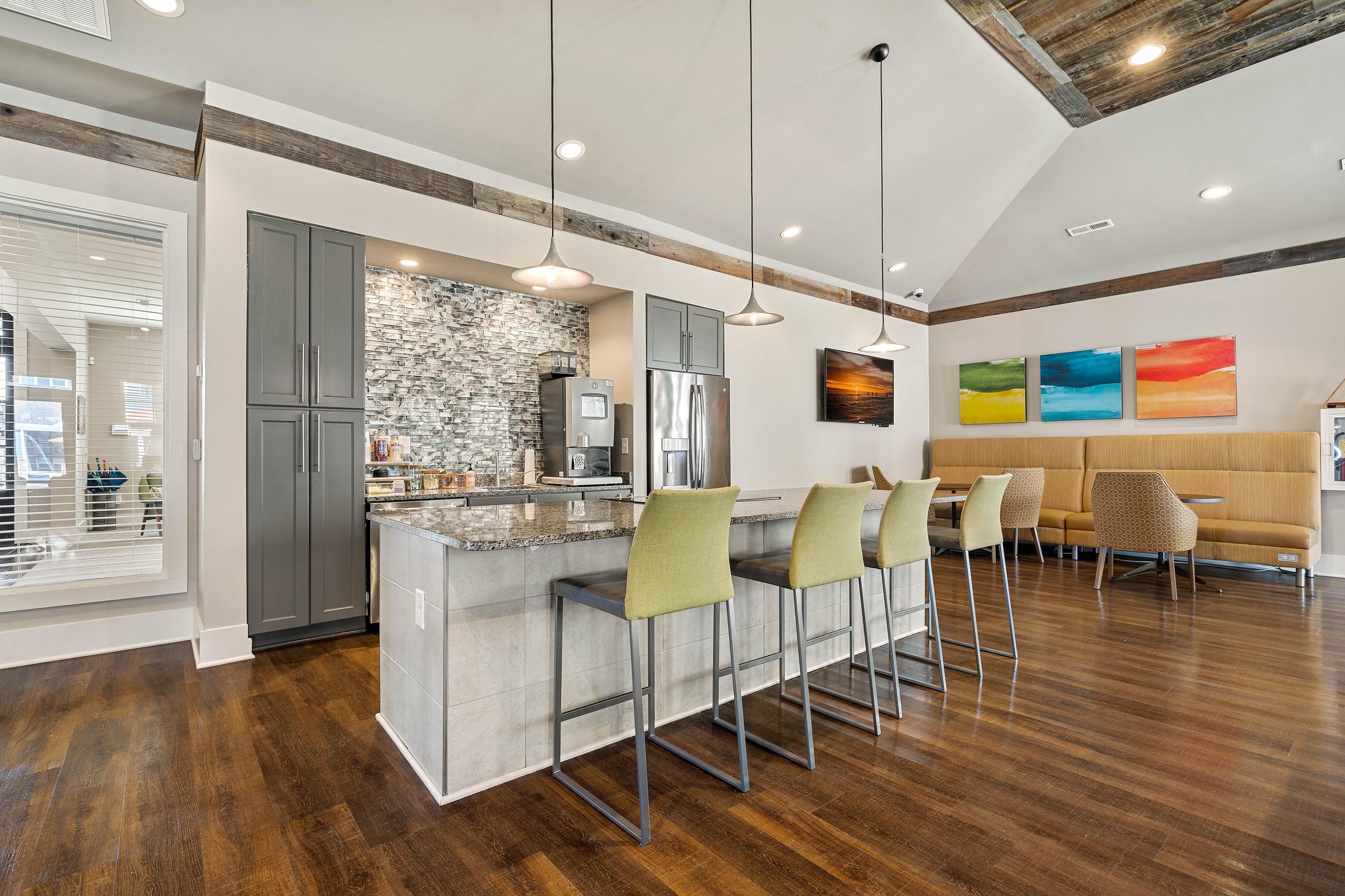 a kitchen with a bar and a dining area with chairs