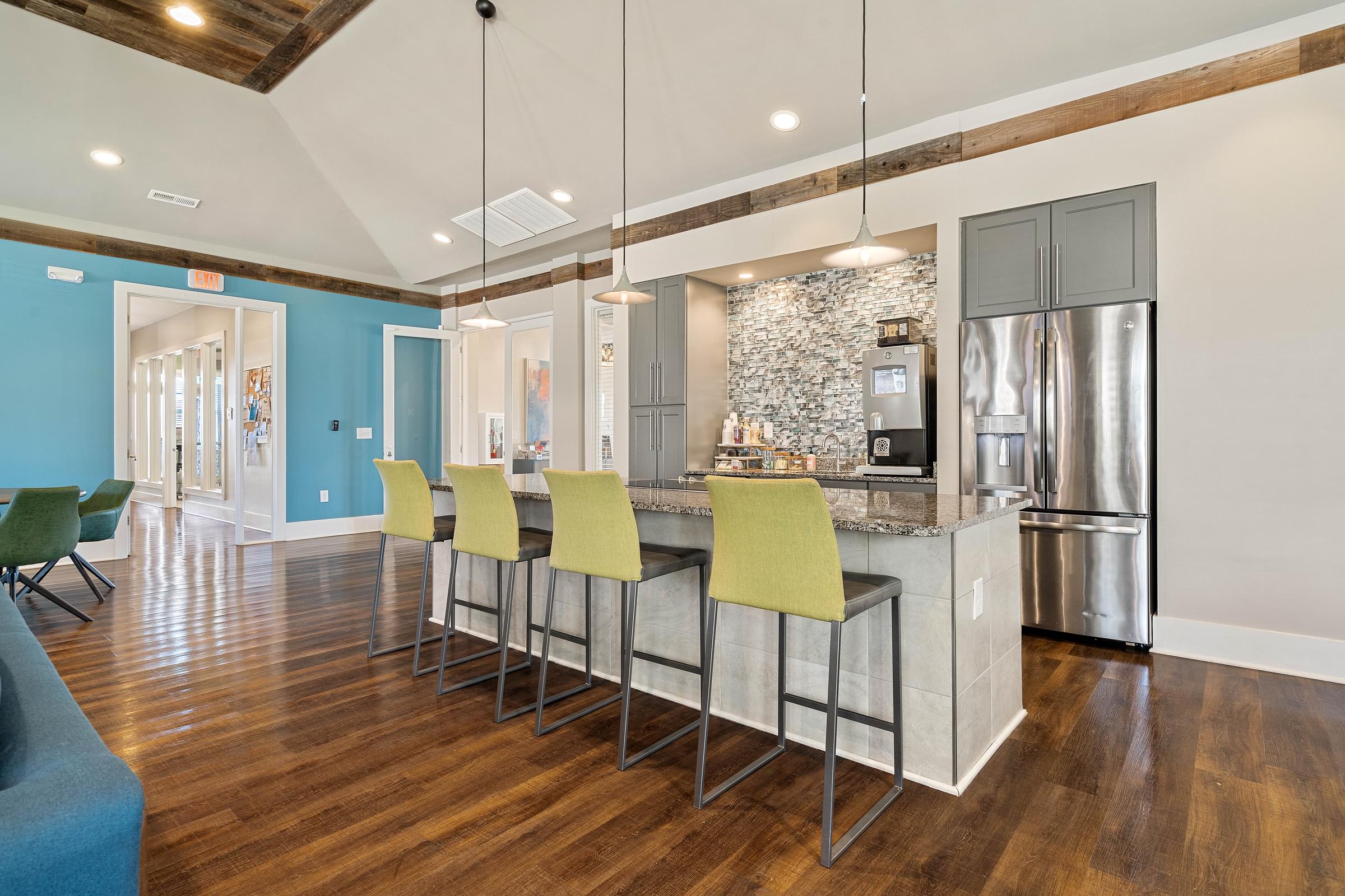 a kitchen with a large island with bar stools