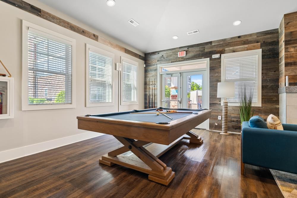 a game room with a pool table and a blue couch