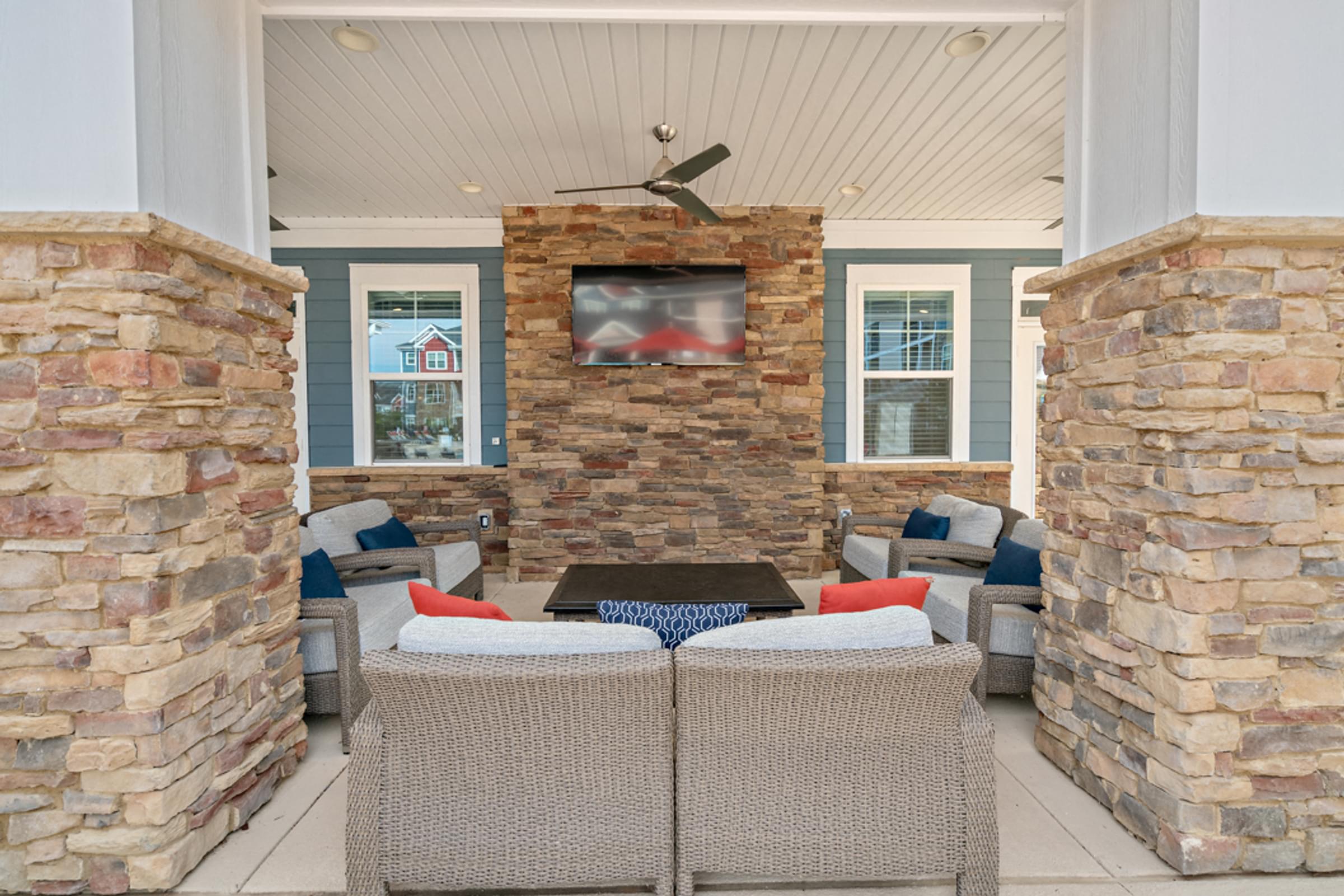 the screened porch has a table with chairs and a tv