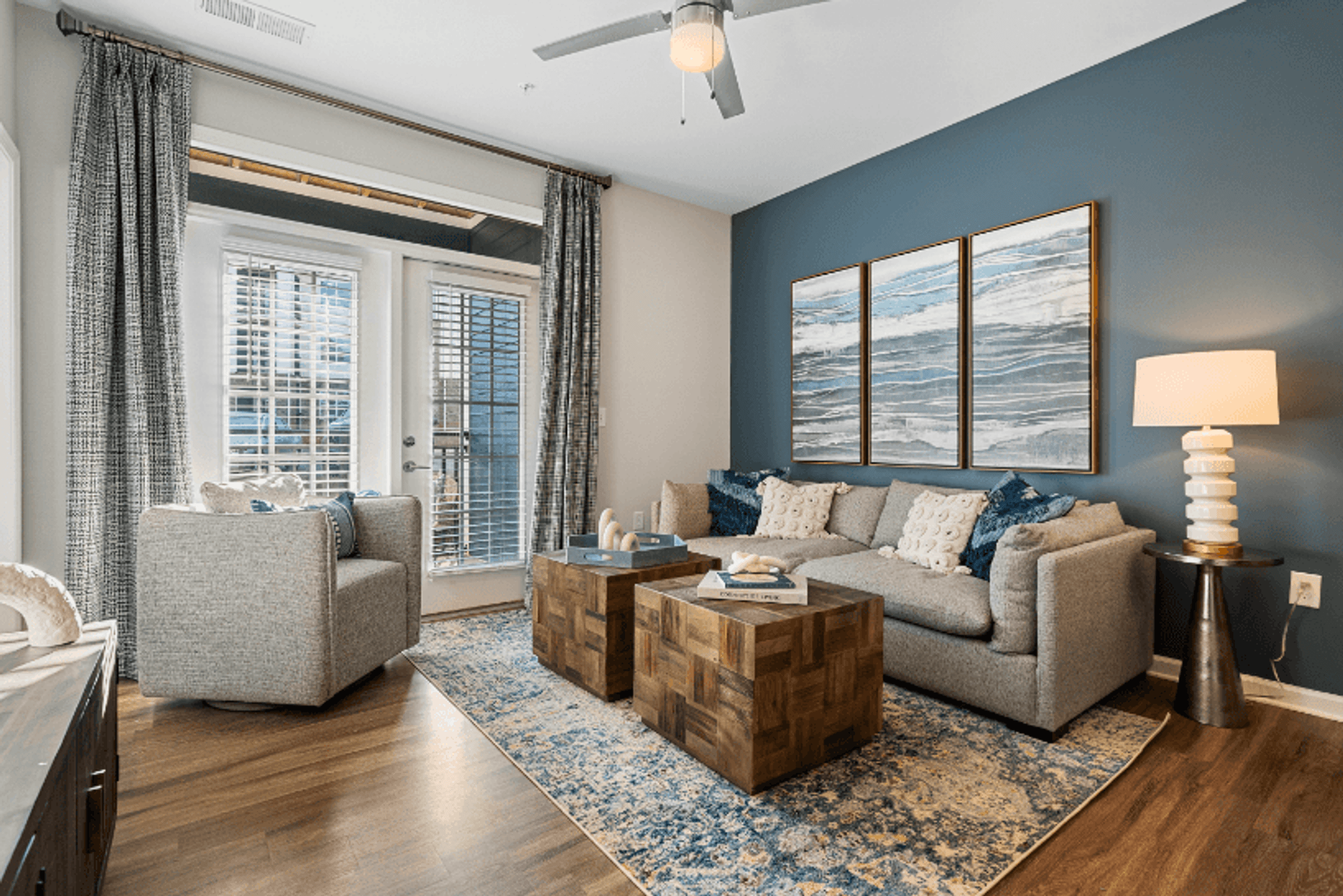 a living room with a couch and chairs and a table