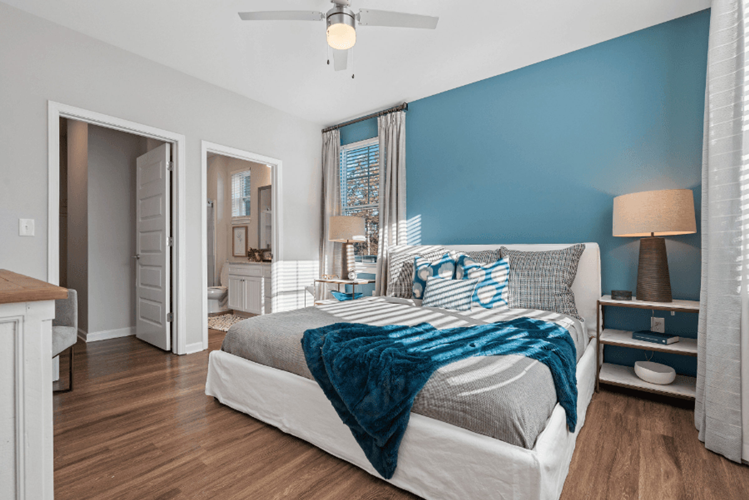 a bedroom with a large bed and a bathroom