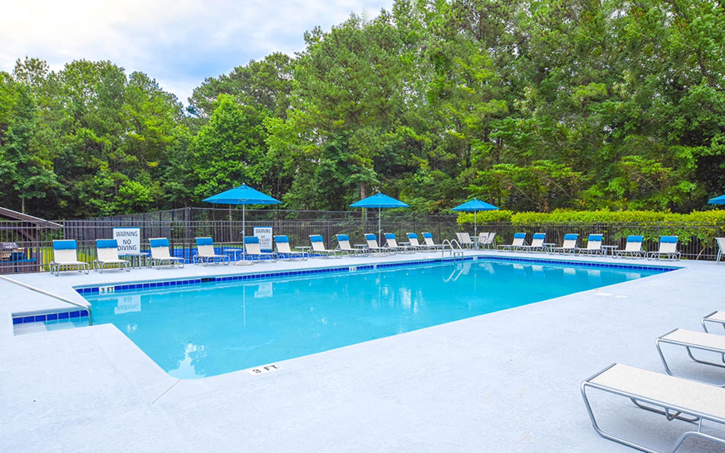 Swimming Pool with Lounge Chairs and Umbrellas